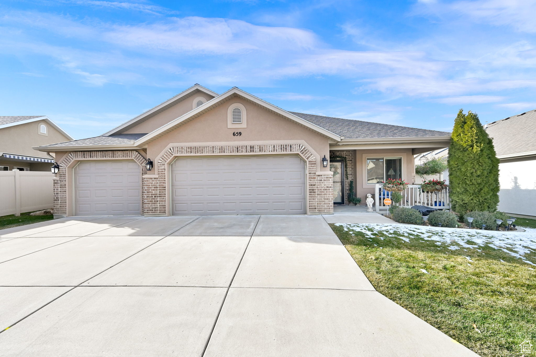 Ranch-style home with covered porch and a garage