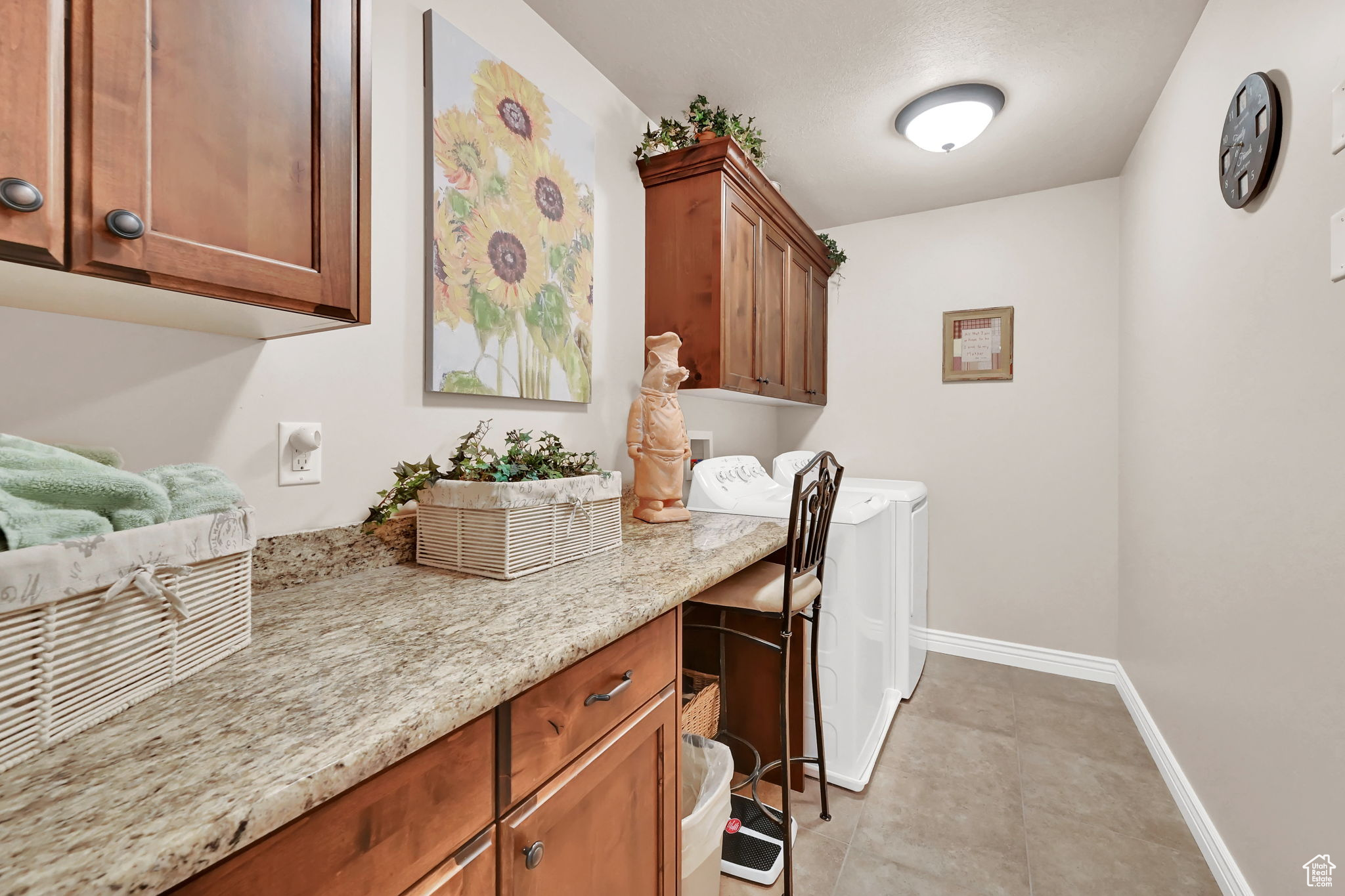 Clothes washing area with separate washer and dryer and cabinets