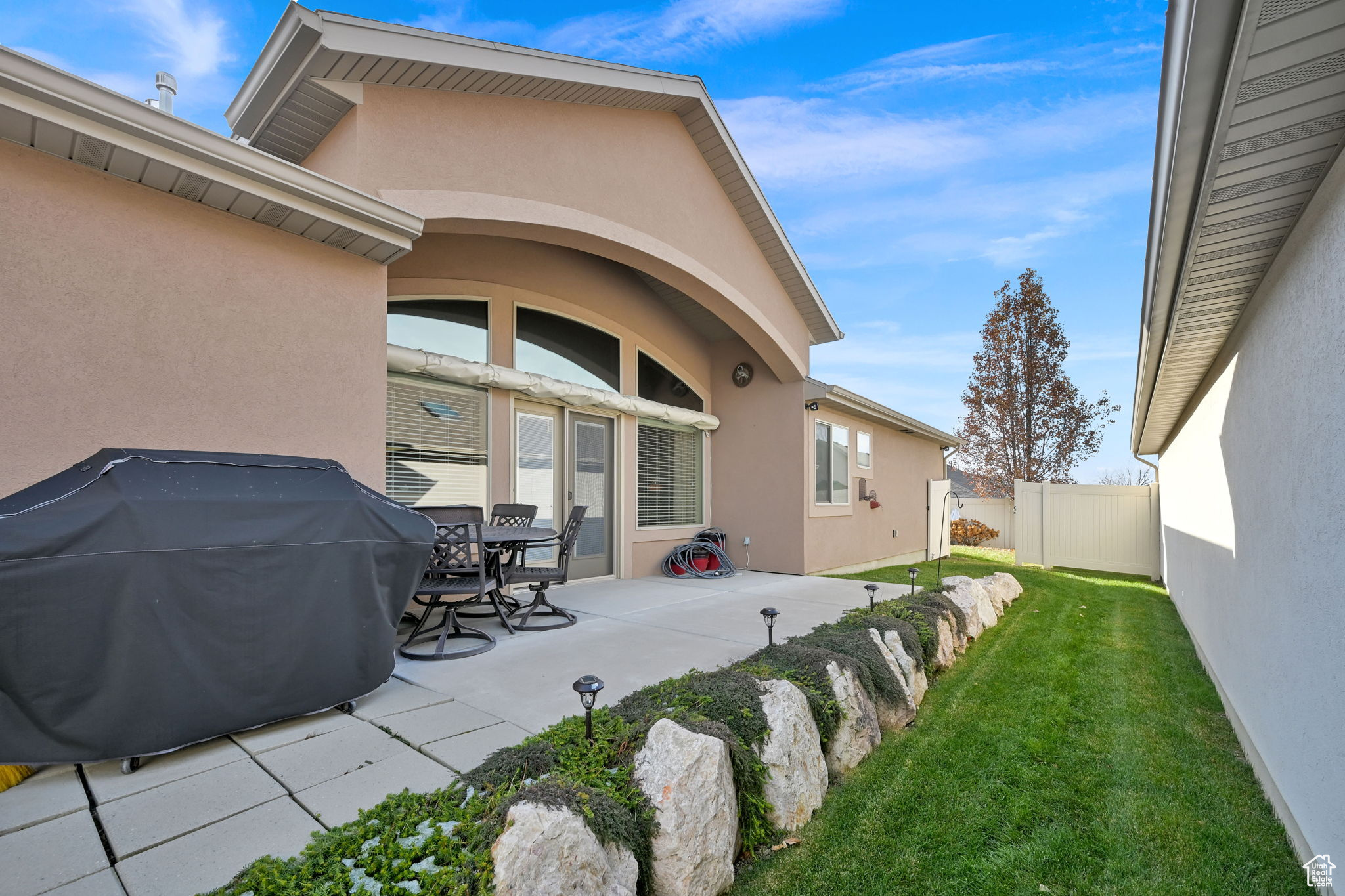 Exterior space featuring a patio area and a lawn