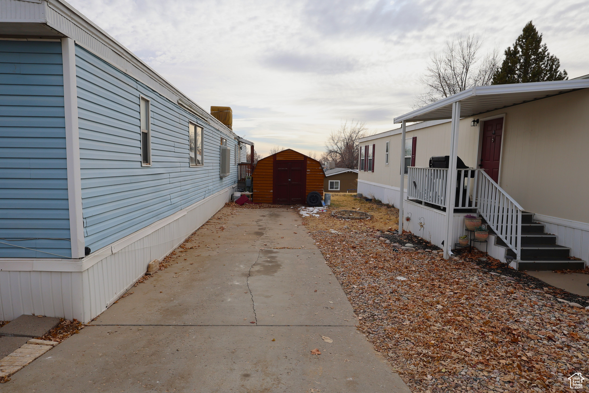 View of side of property with a storage shed