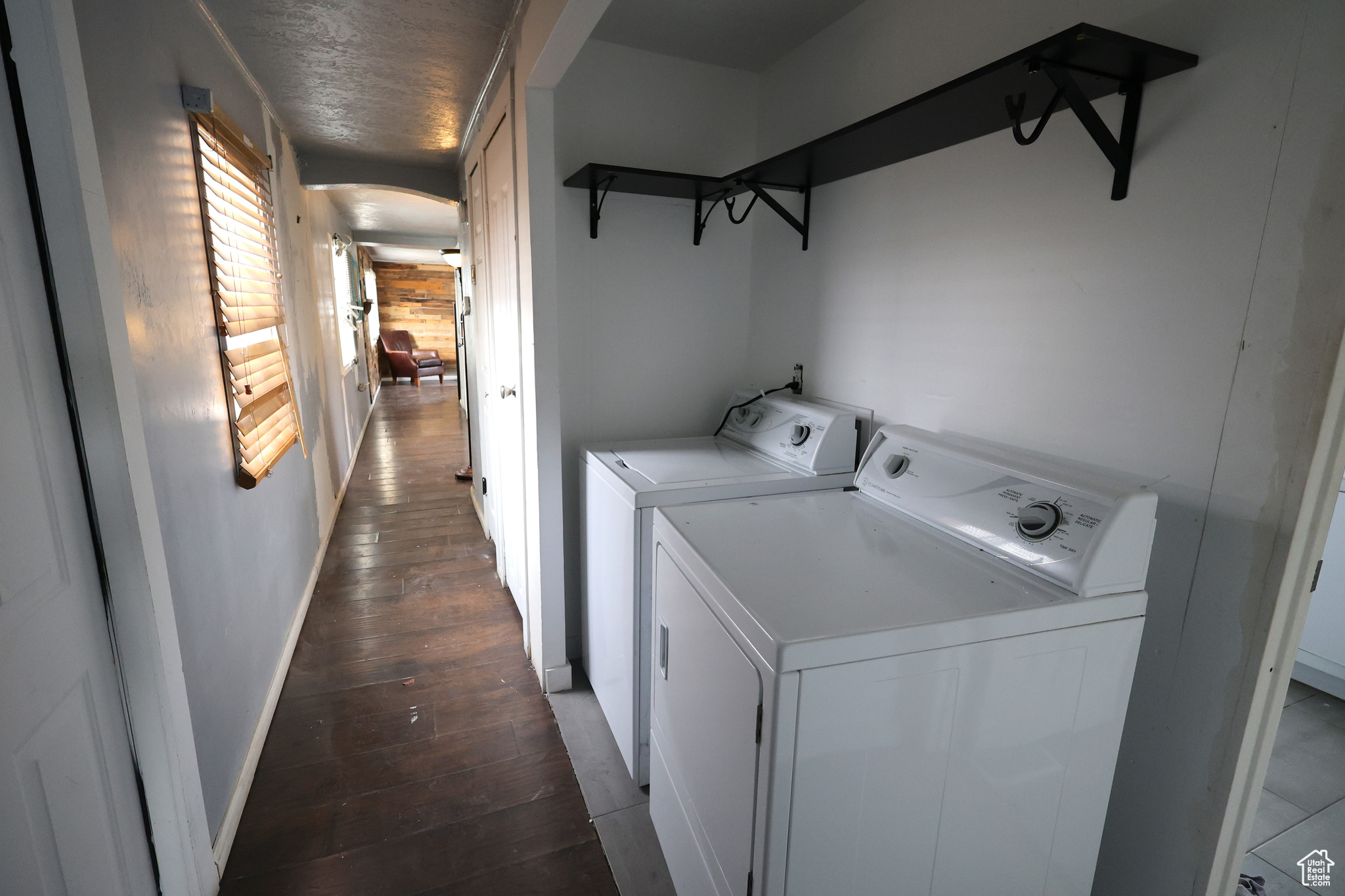 Laundry area with washer and dryer and dark hardwood / wood-style flooring