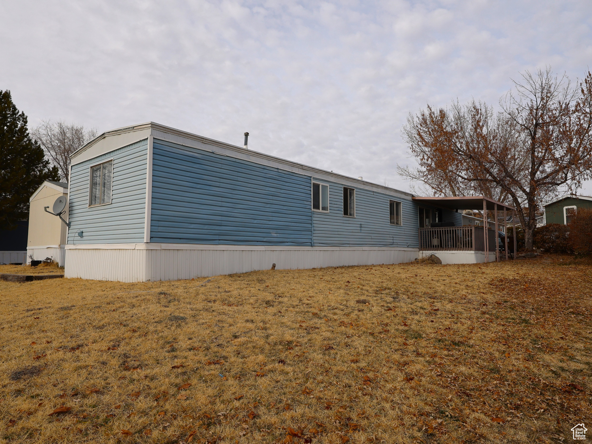 View of property exterior featuring a lawn