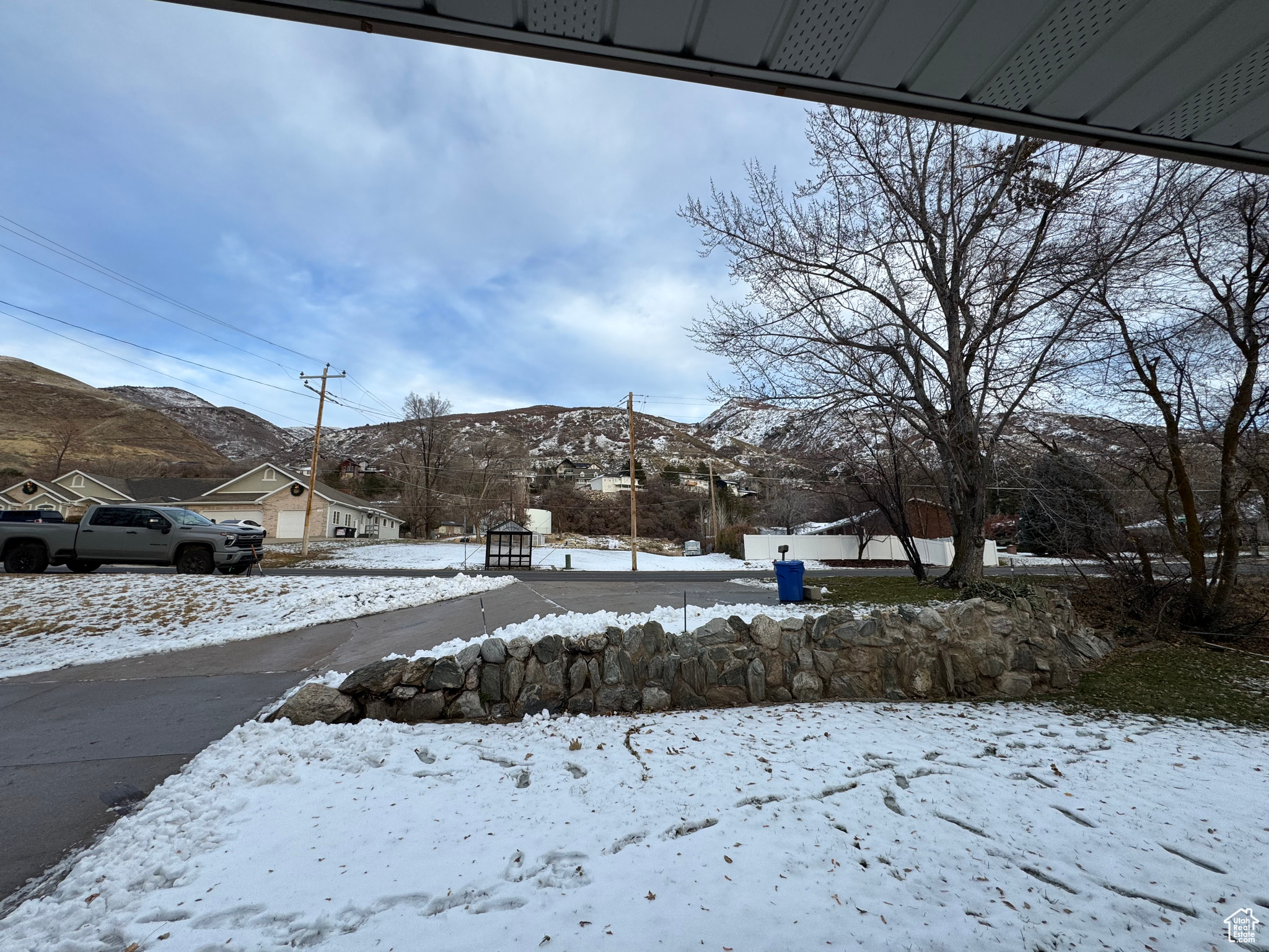 Yard layered in snow featuring a mountain view