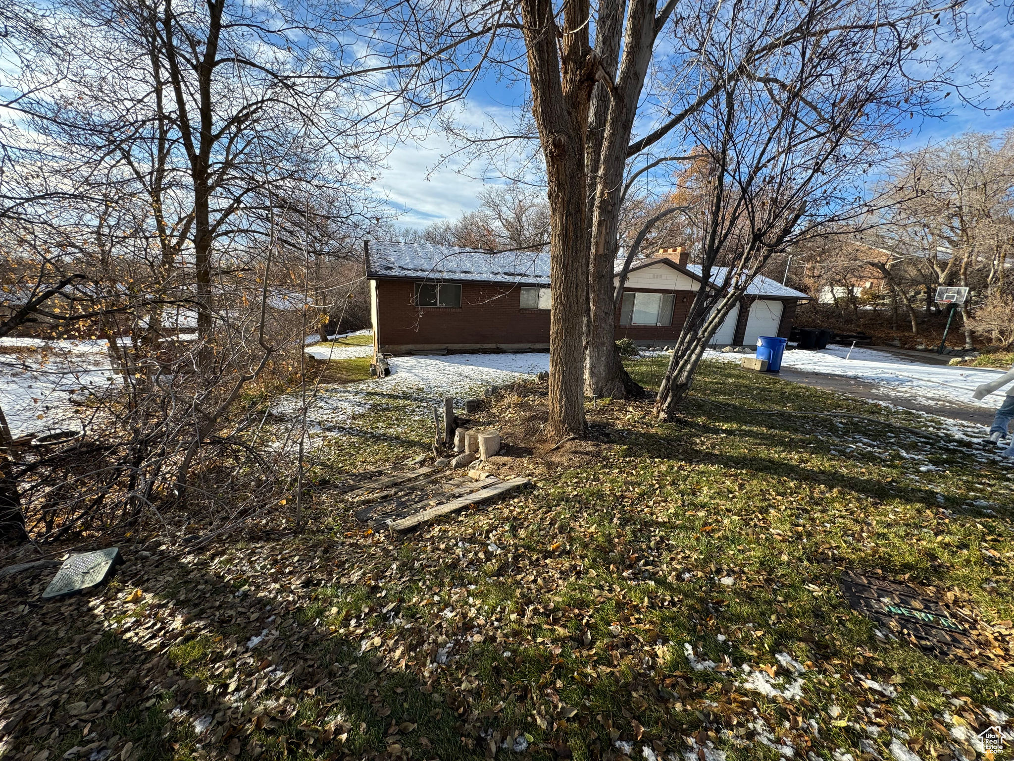 Front yard covered in snow with a garage