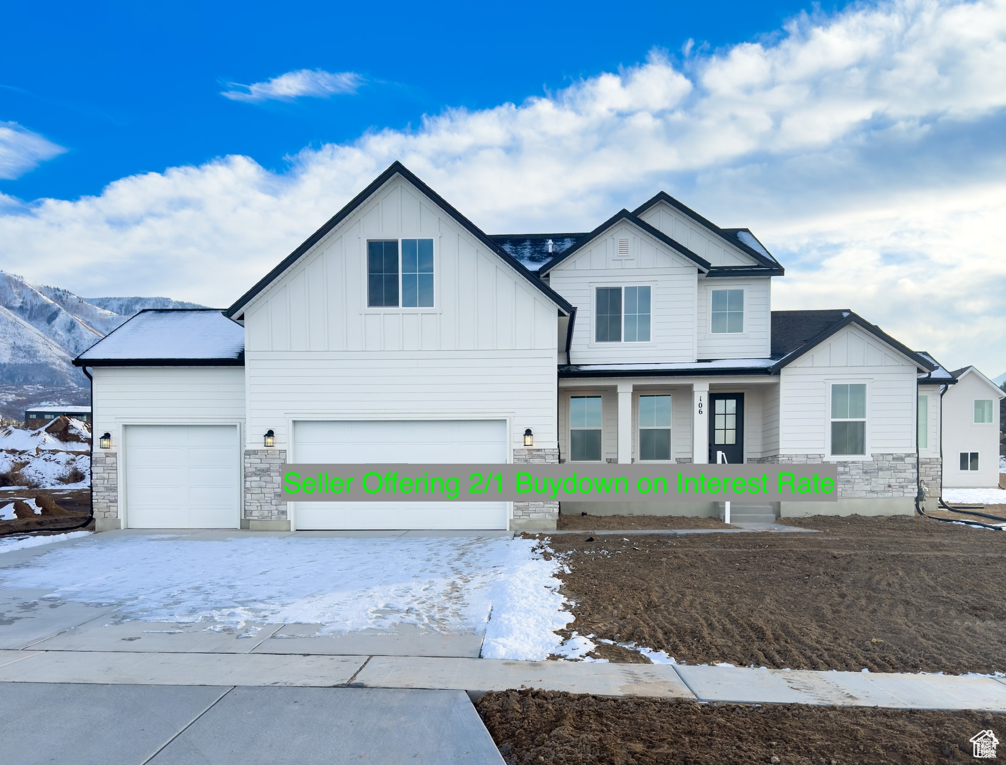 View of front of house with a garage and a mountain view