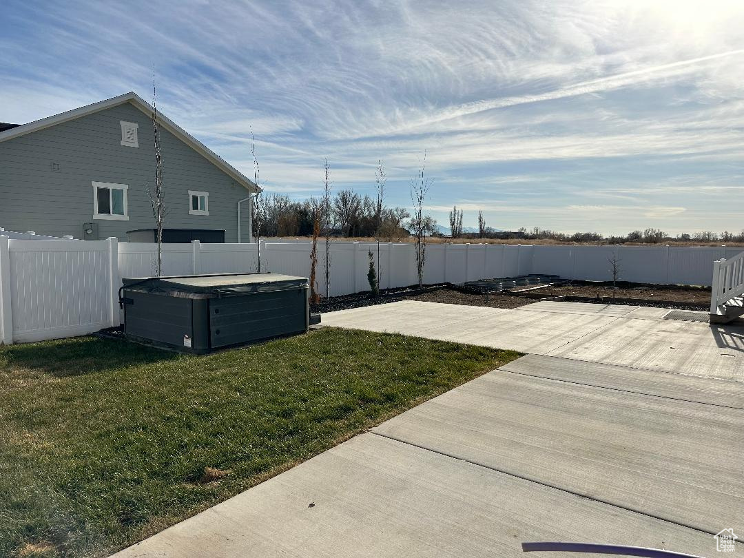 View of yard with a patio and a hot tub