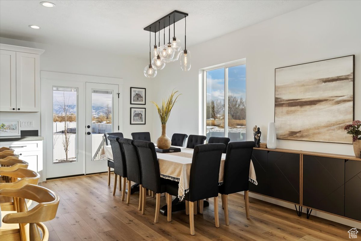 Dining room with french doors and light hardwood / wood-style flooring