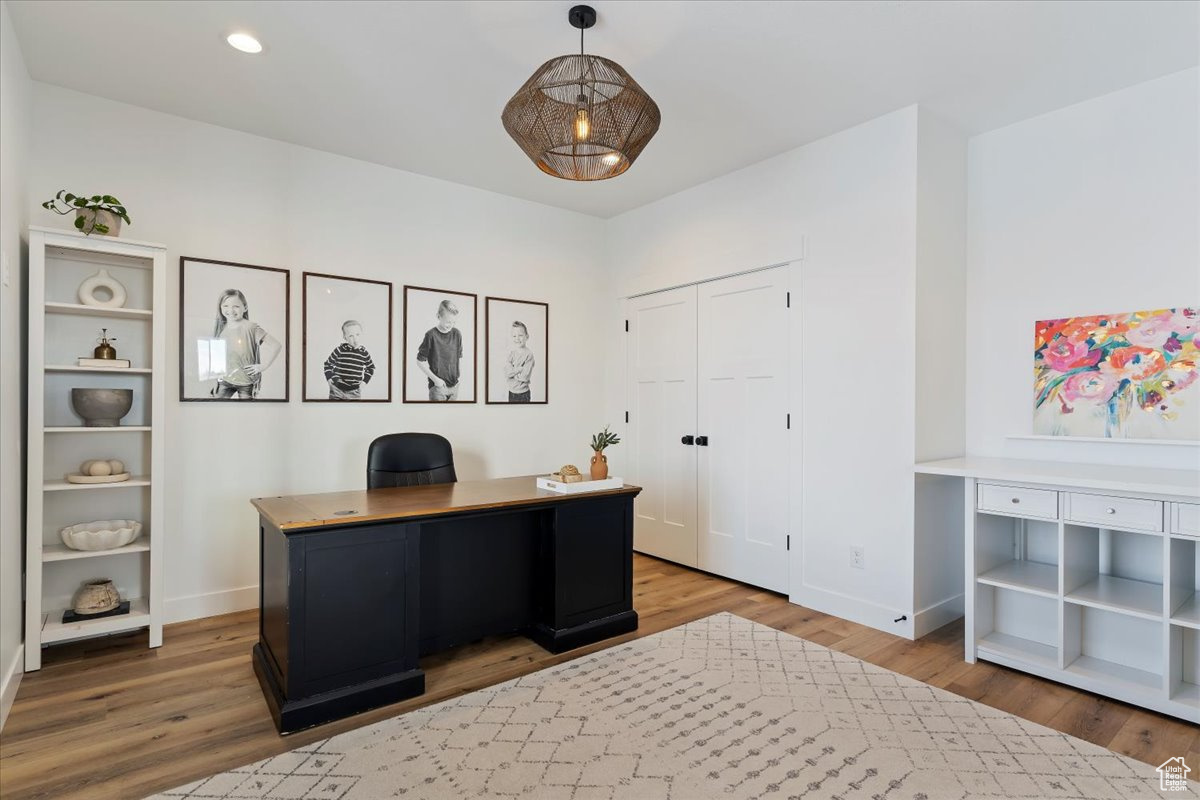 Office with hardwood / wood-style floors