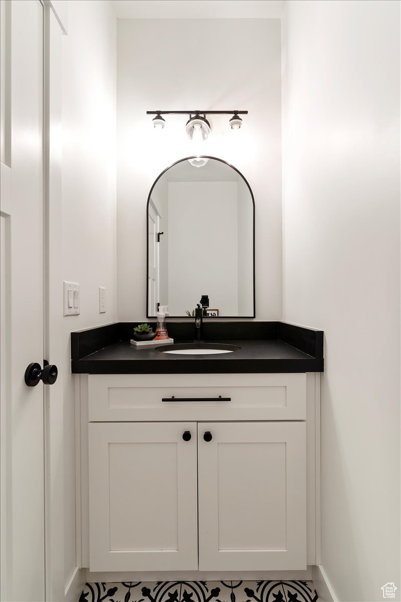 Bathroom featuring tile patterned flooring and vanity