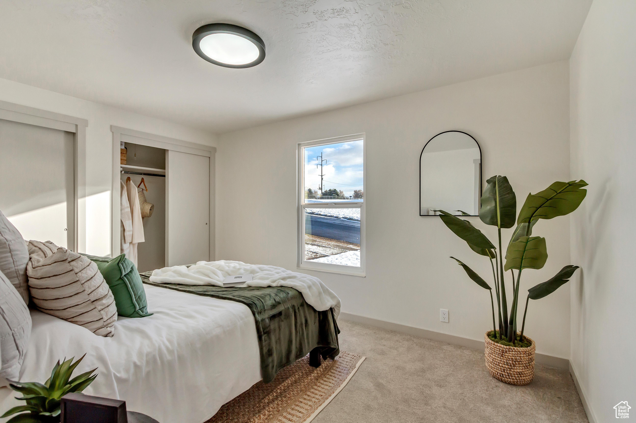 Carpeted bedroom with a closet