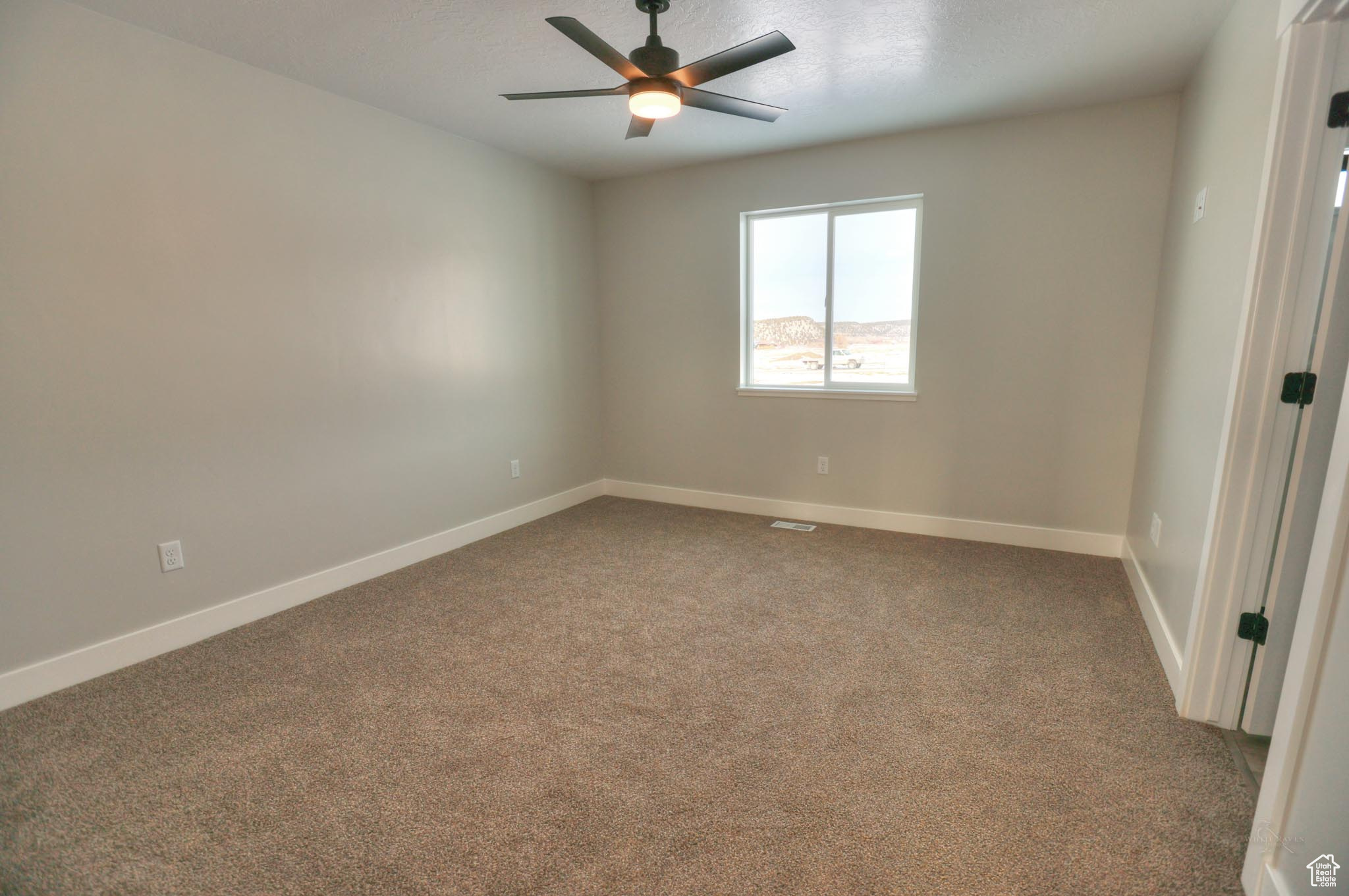 Master bedroom with ceiling fan and carpet floors