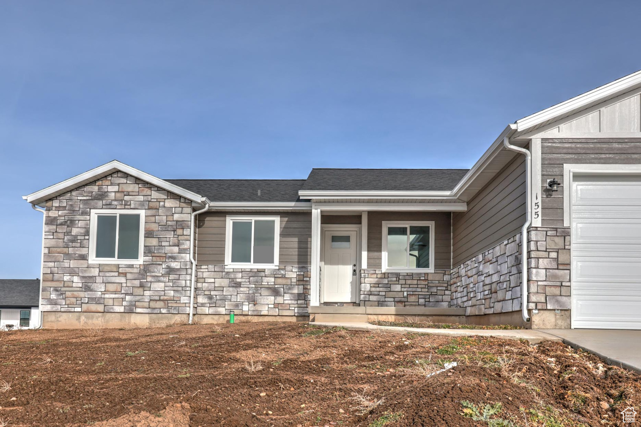 View of front facade featuring a garage