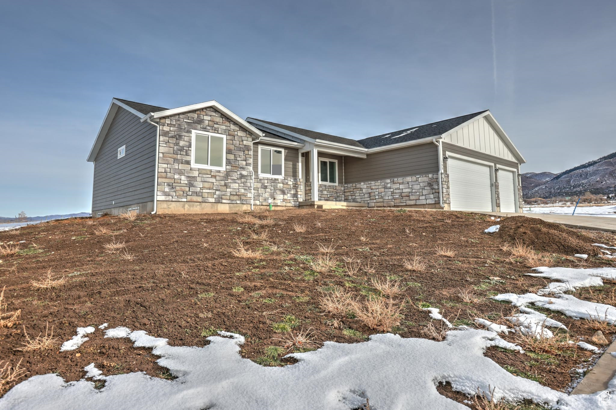 View of front of home featuring a mountain view and a garage