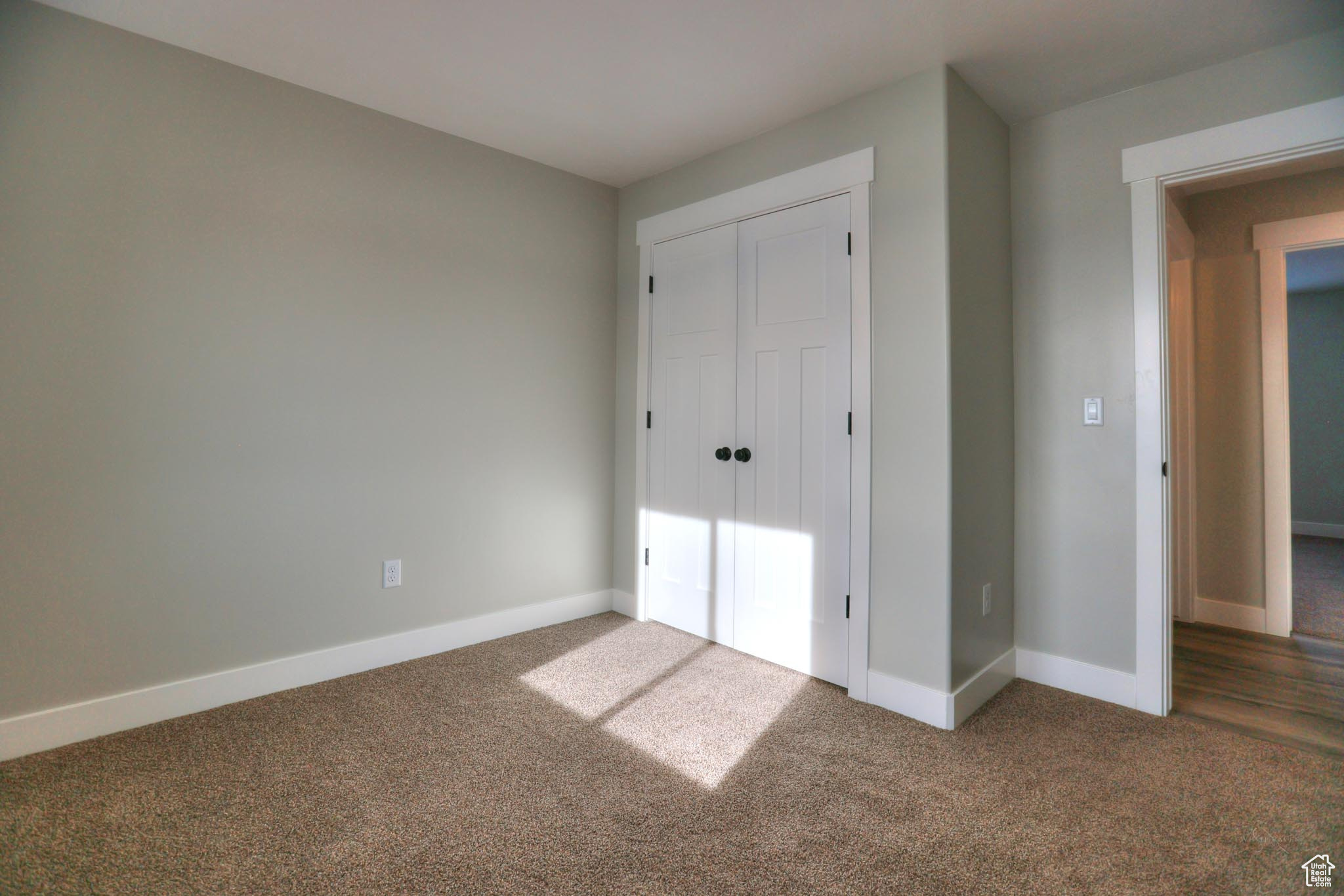 Unfurnished bedroom with carpet and a closet