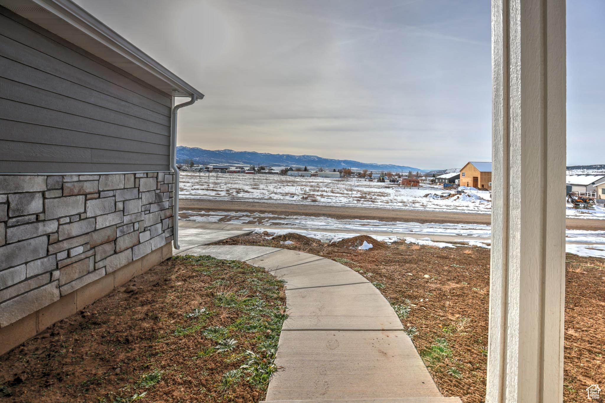 Yard layered in snow featuring a mountain view