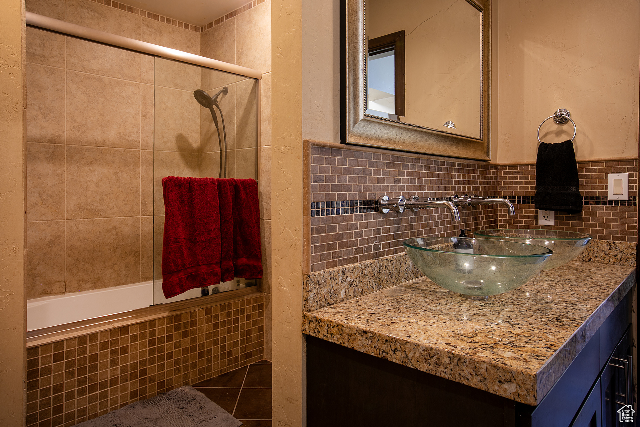 Bathroom with vanity, tiled shower / bath combo, and tile patterned floors