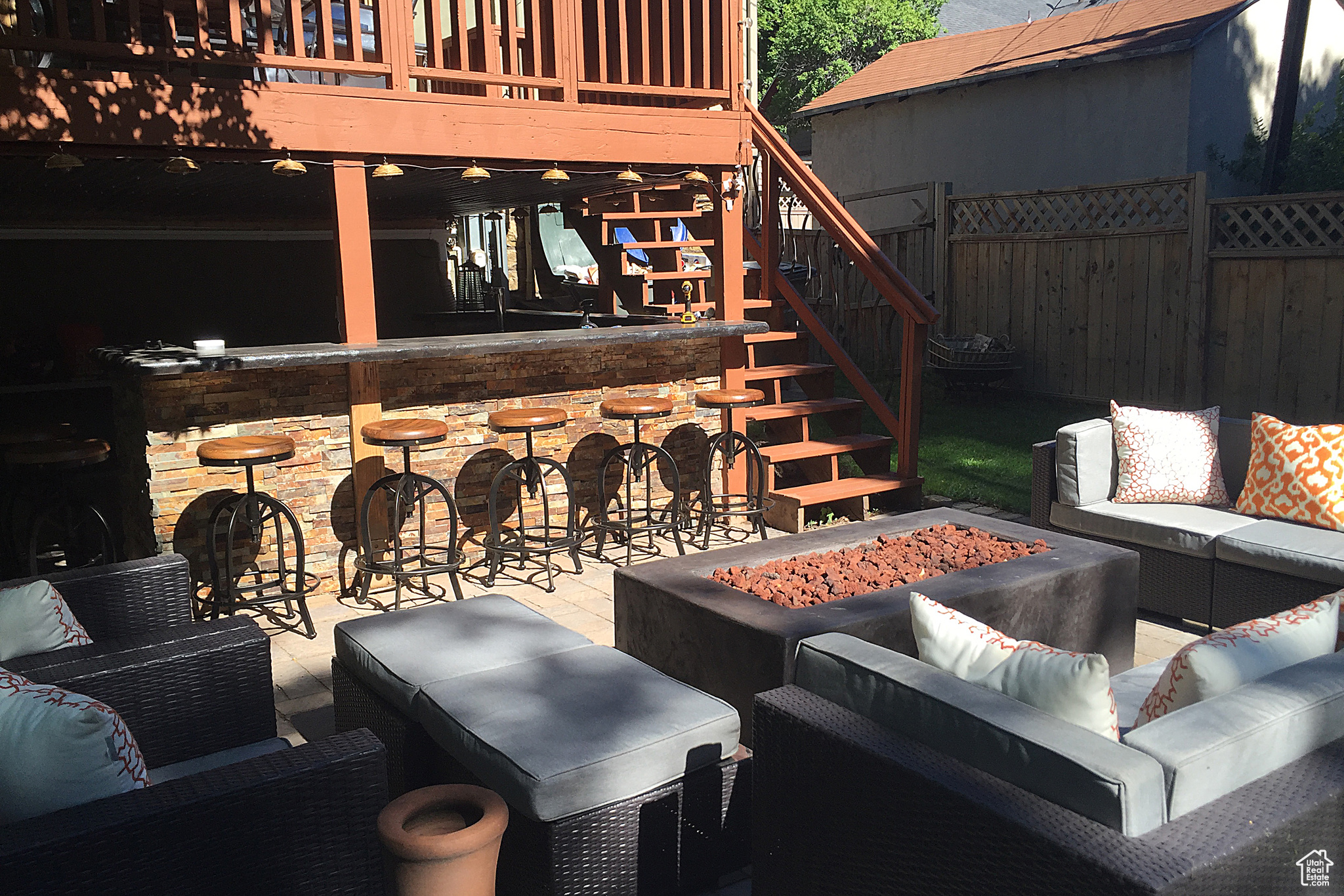 View of patio / terrace with a bar and an outdoor living space with a fire pit