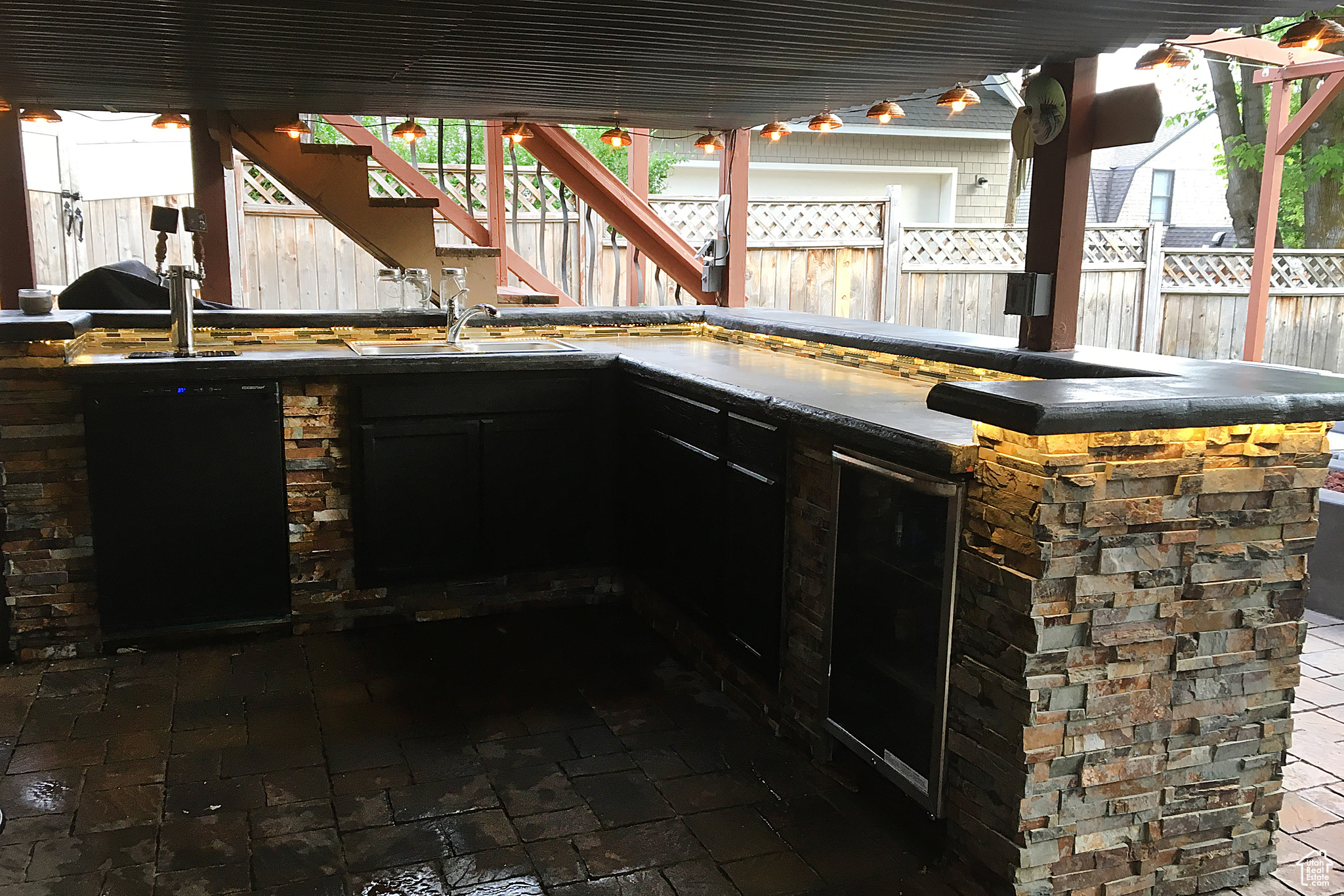 View of patio featuring sink and beverage cooler