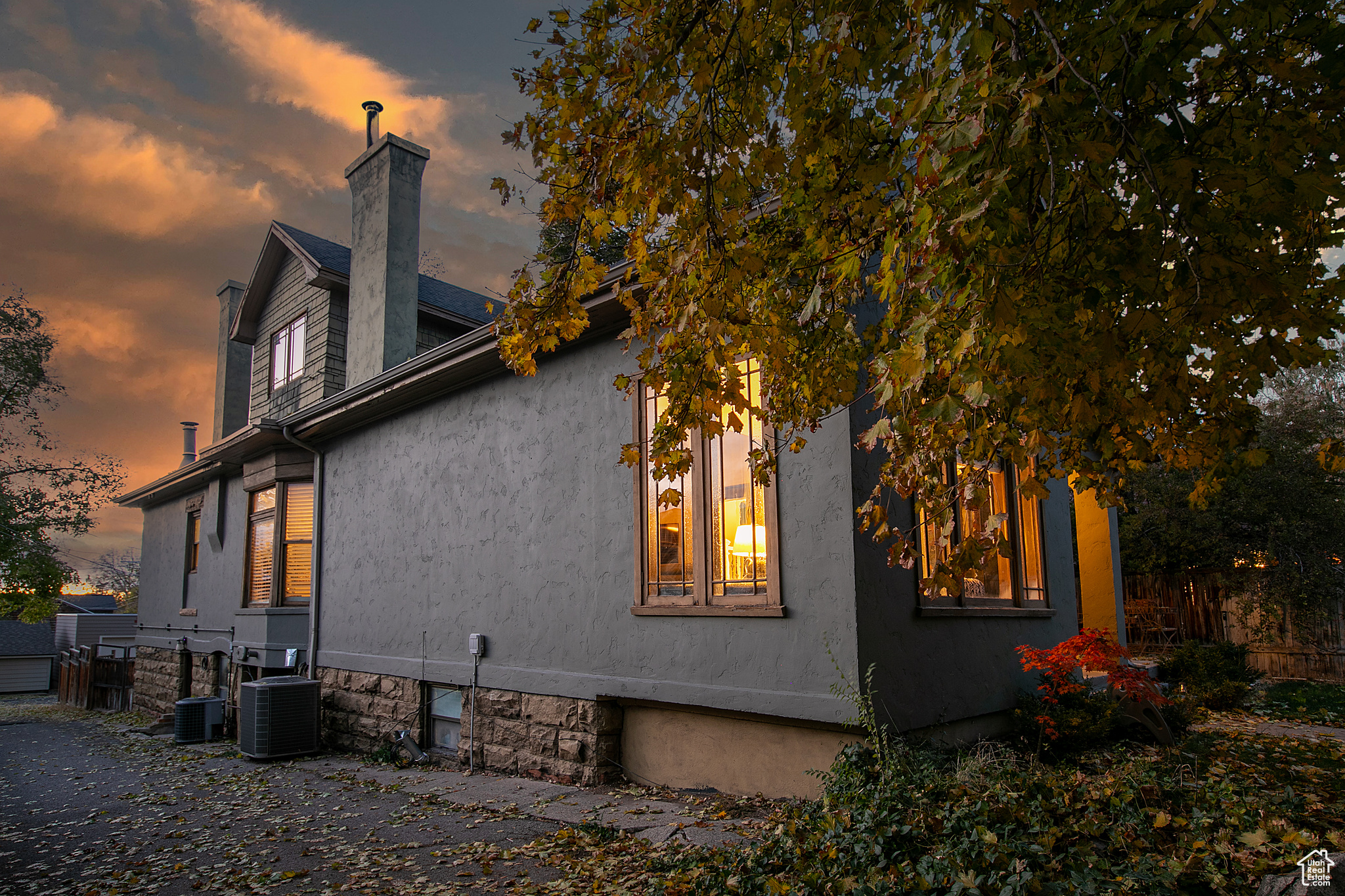 Property exterior at dusk featuring cooling unit