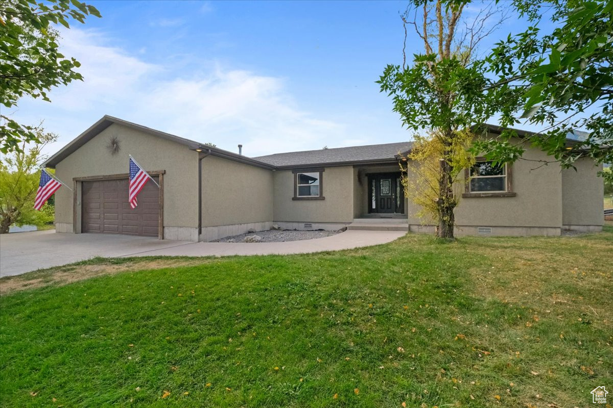 Back of property featuring a yard and a garage