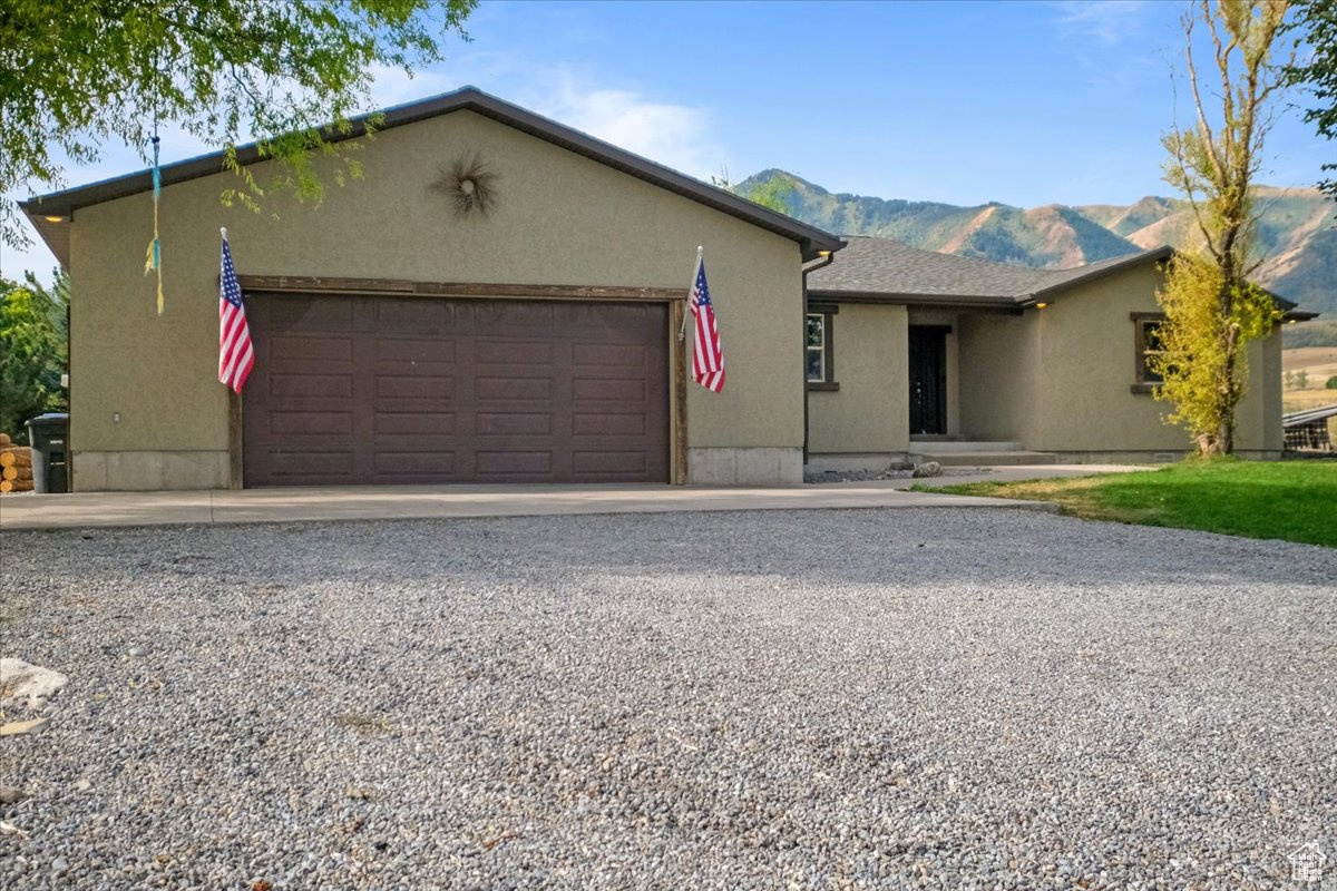 Ranch-style home featuring a mountain view and a garage