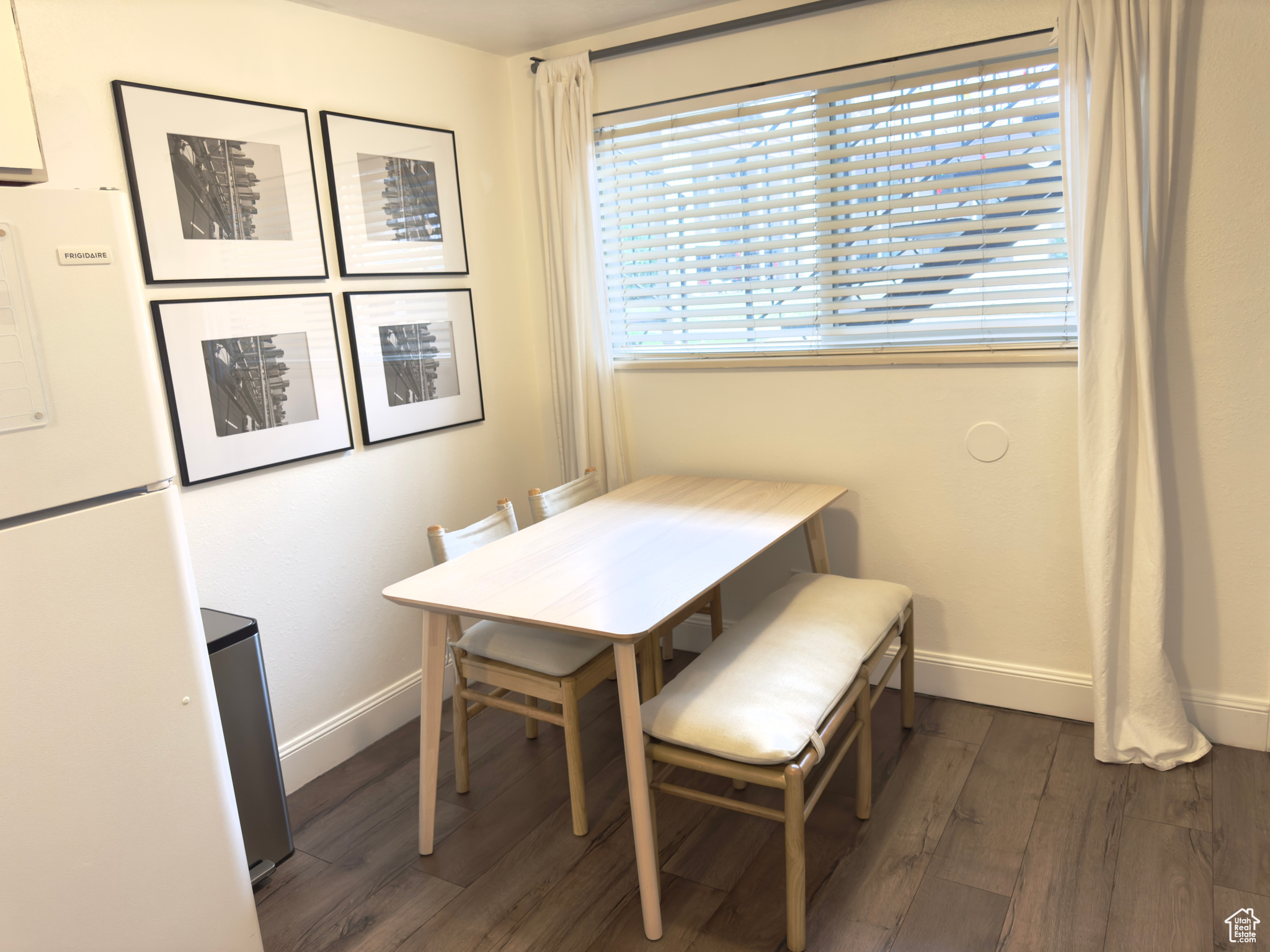 Dining room with dark hardwood / wood-style floors