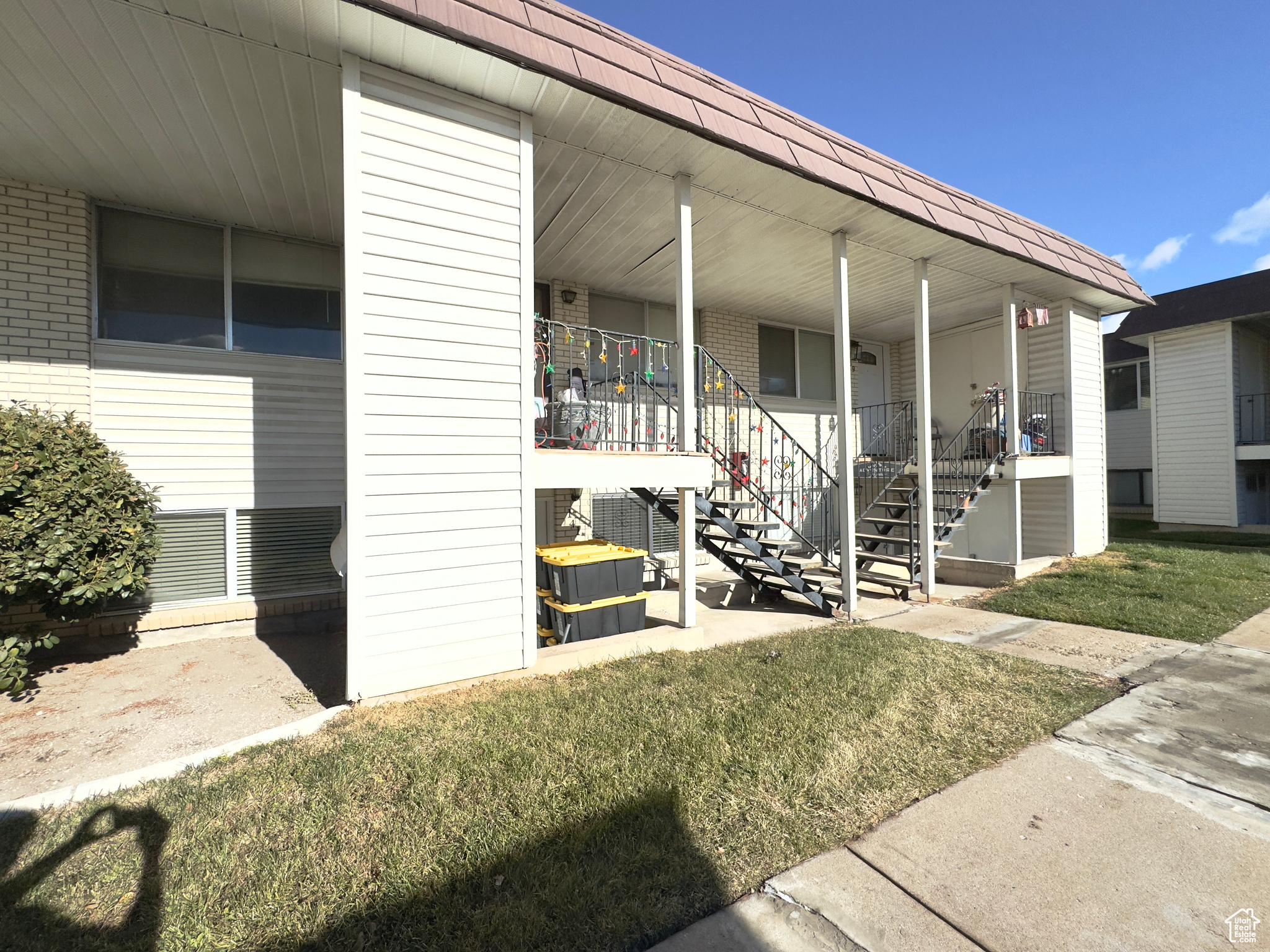 Property entrance featuring a lawn and covered porch