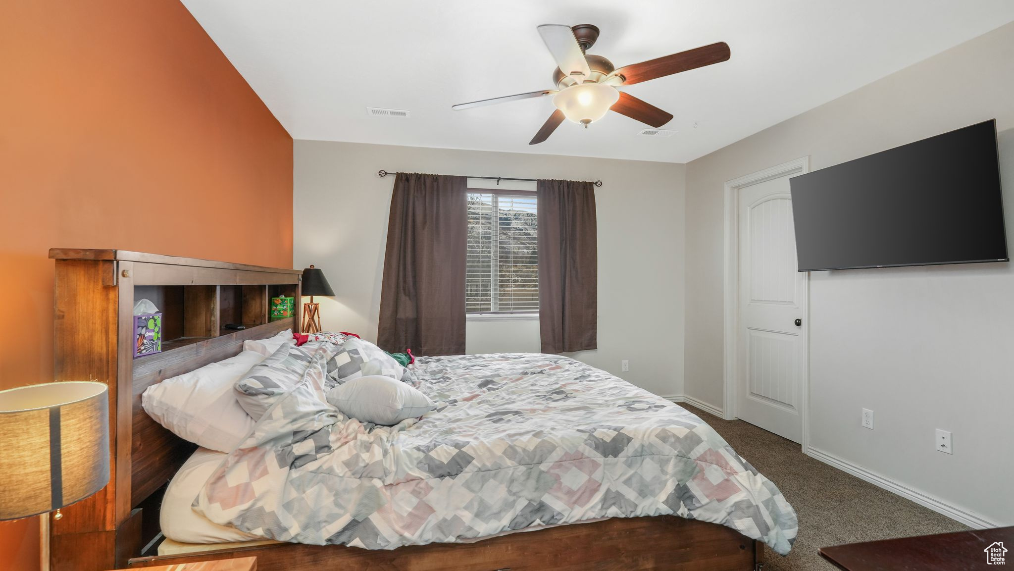 Carpeted master bedroom with ceiling fan and view of mountain