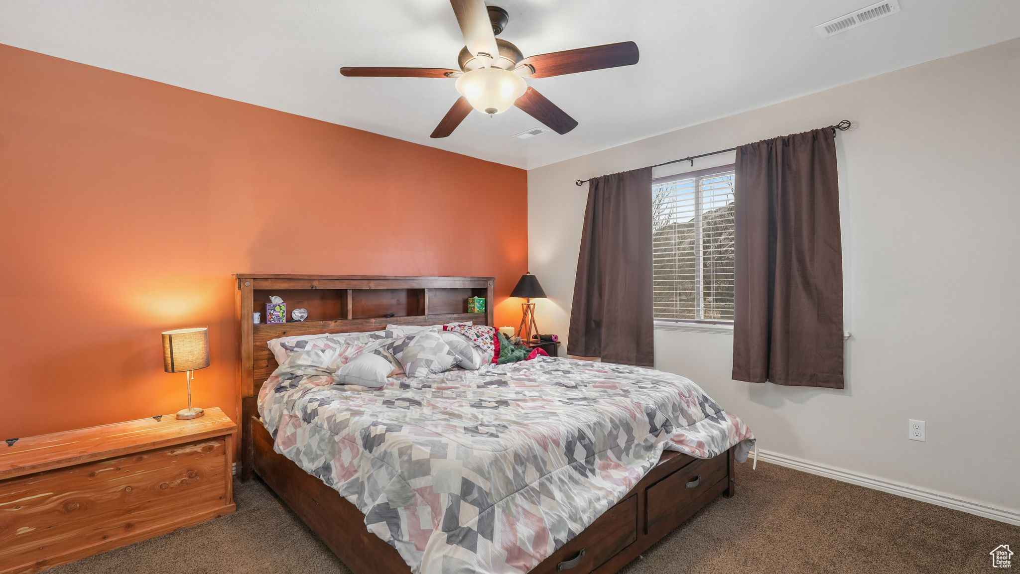 Carpeted master bedroom with ceiling fan and view of mountain