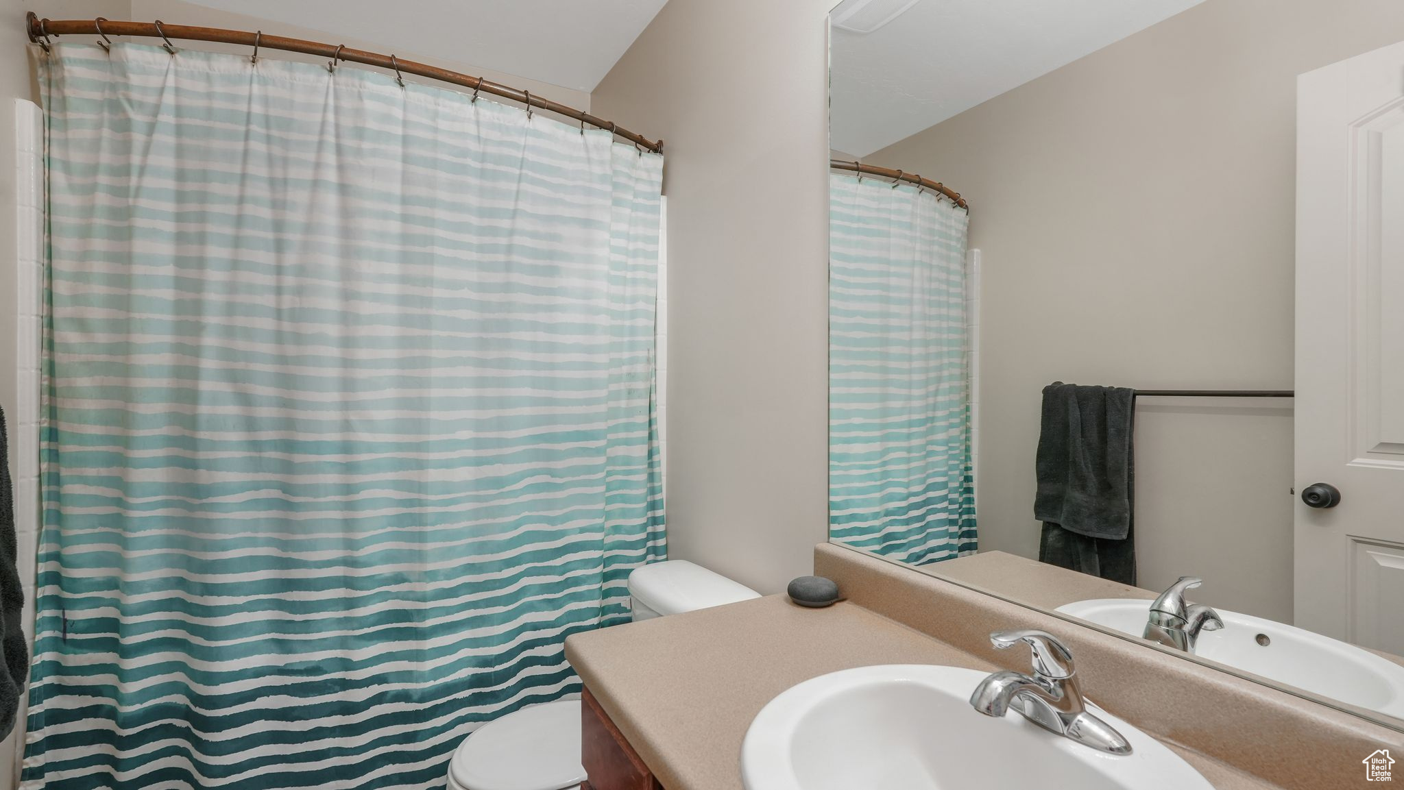 Master bathroom featuring vanity, curtained shower, and toilet