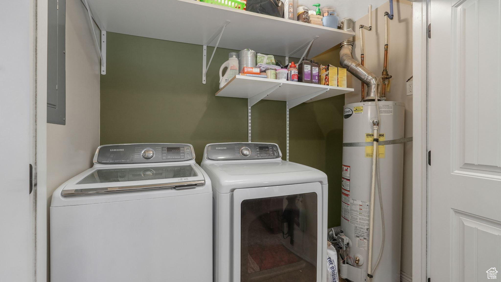 Washroom featuring washing machine and clothes dryer and water heater