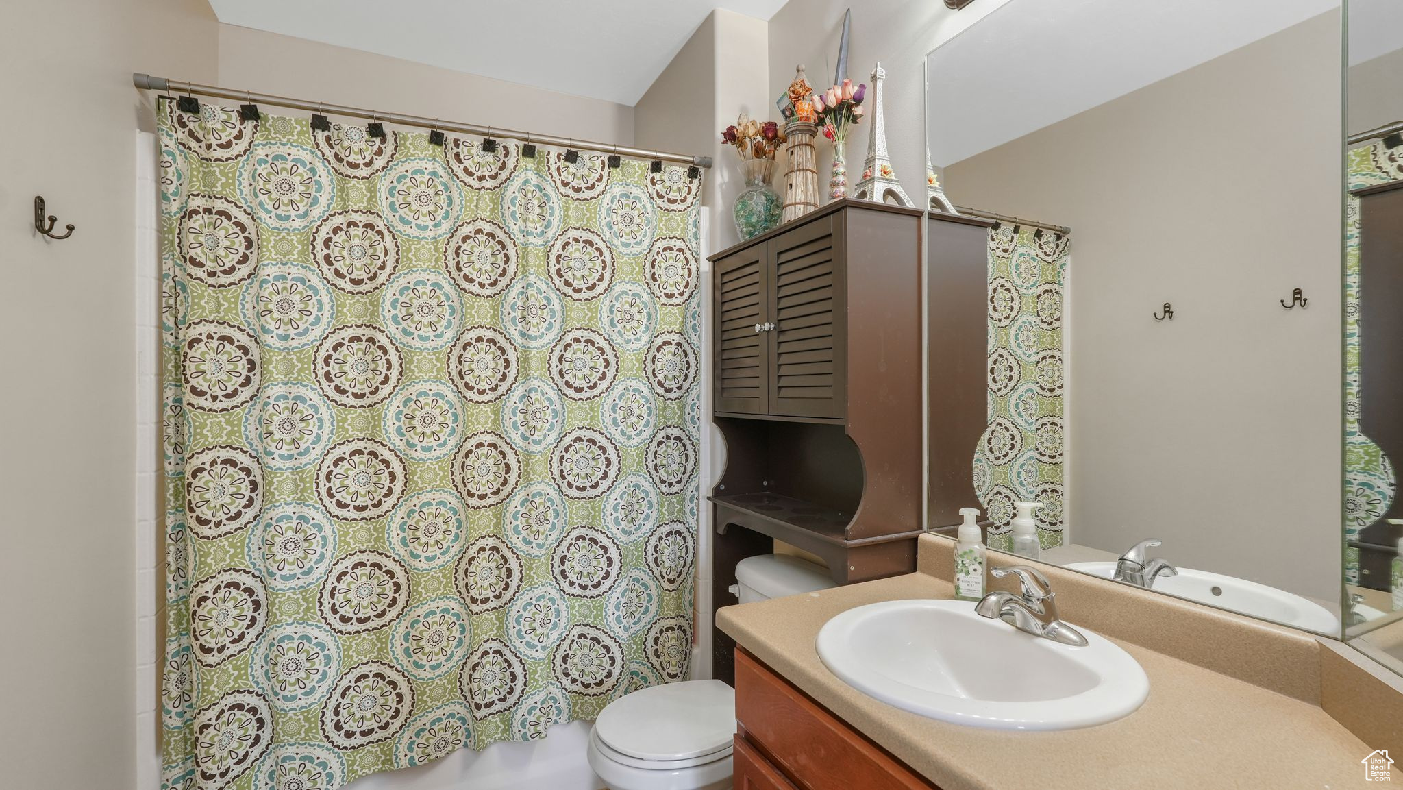 Full bathroom with vanity, toilet, and shower / tub combo with curtain