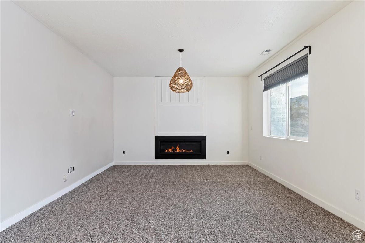 Unfurnished living room with carpet floors