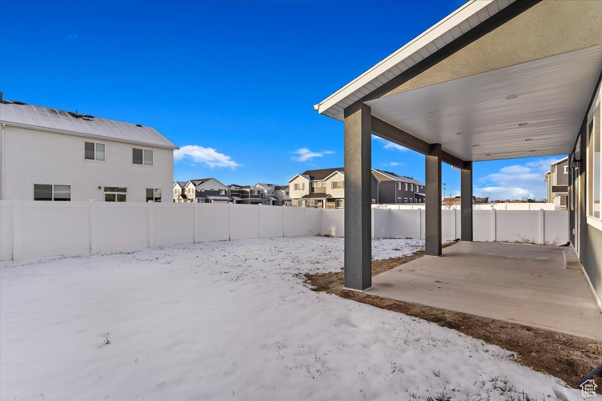 Snowy yard with a patio