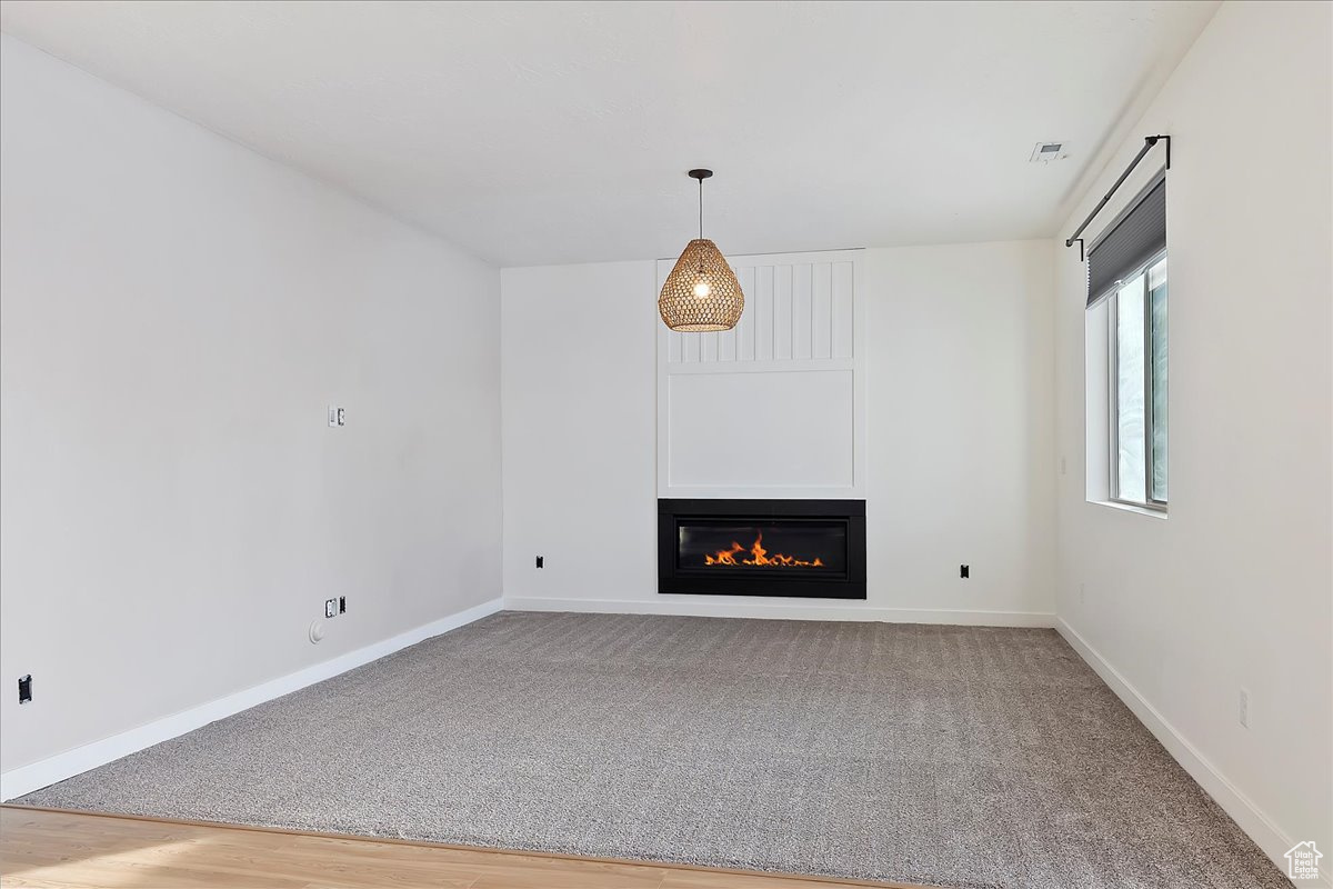 Unfurnished living room with hardwood / wood-style floors