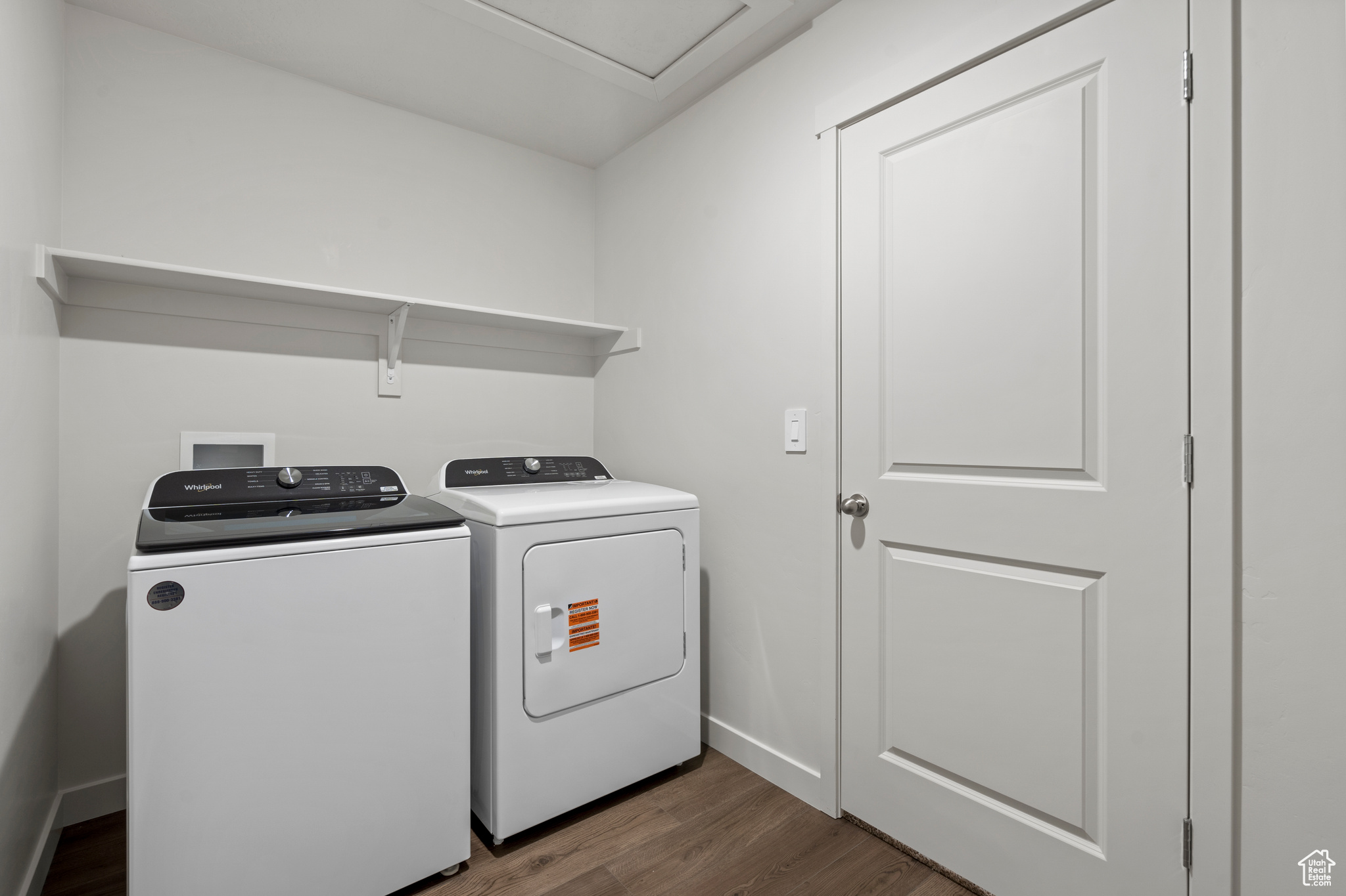 Laundry room with washer and dryer and dark hardwood / wood-style flooring