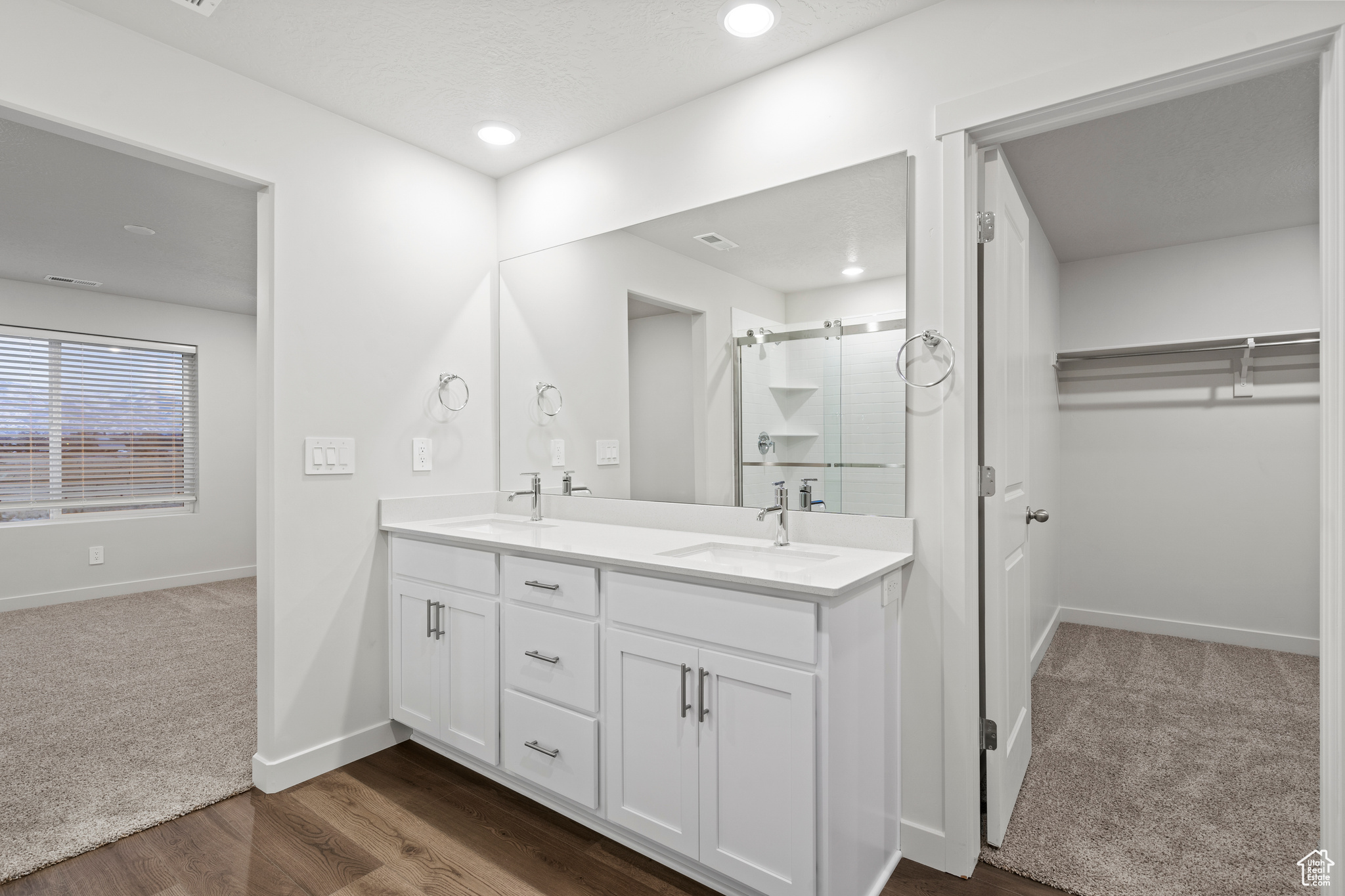 Bathroom featuring vanity, an enclosed shower, and hardwood / wood-style flooring