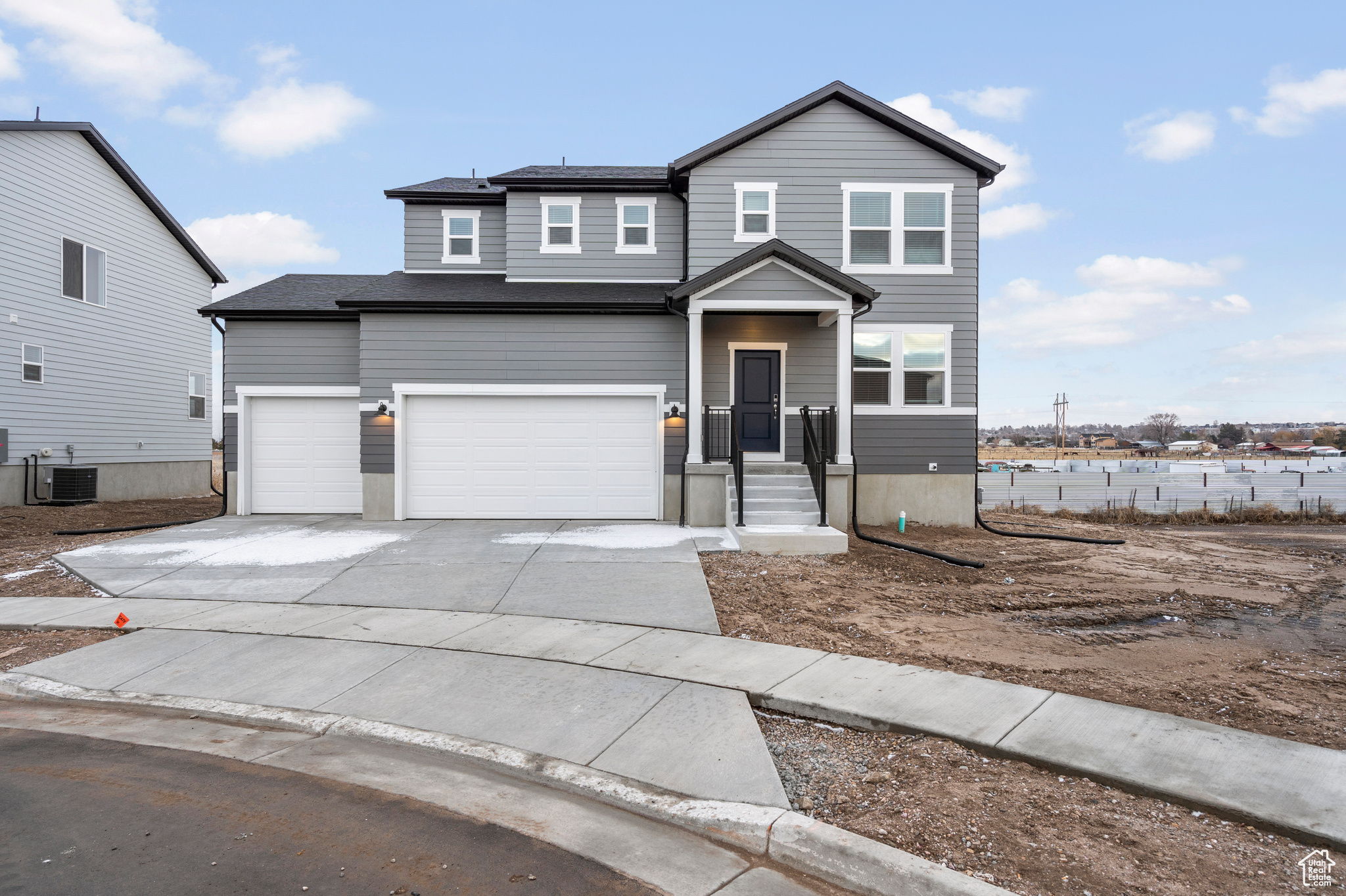 View of front property featuring cooling unit and a garage