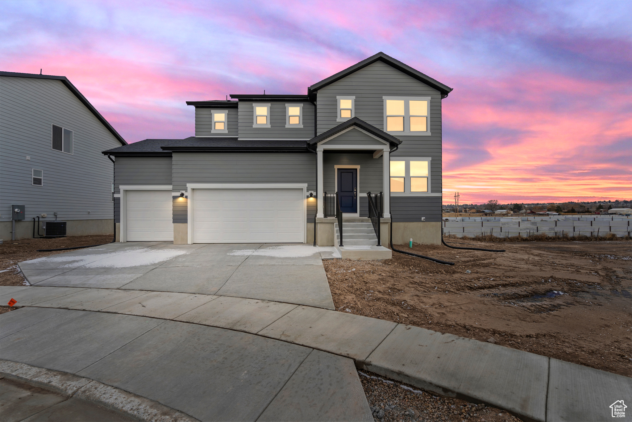 Front of property featuring a garage and central AC unit