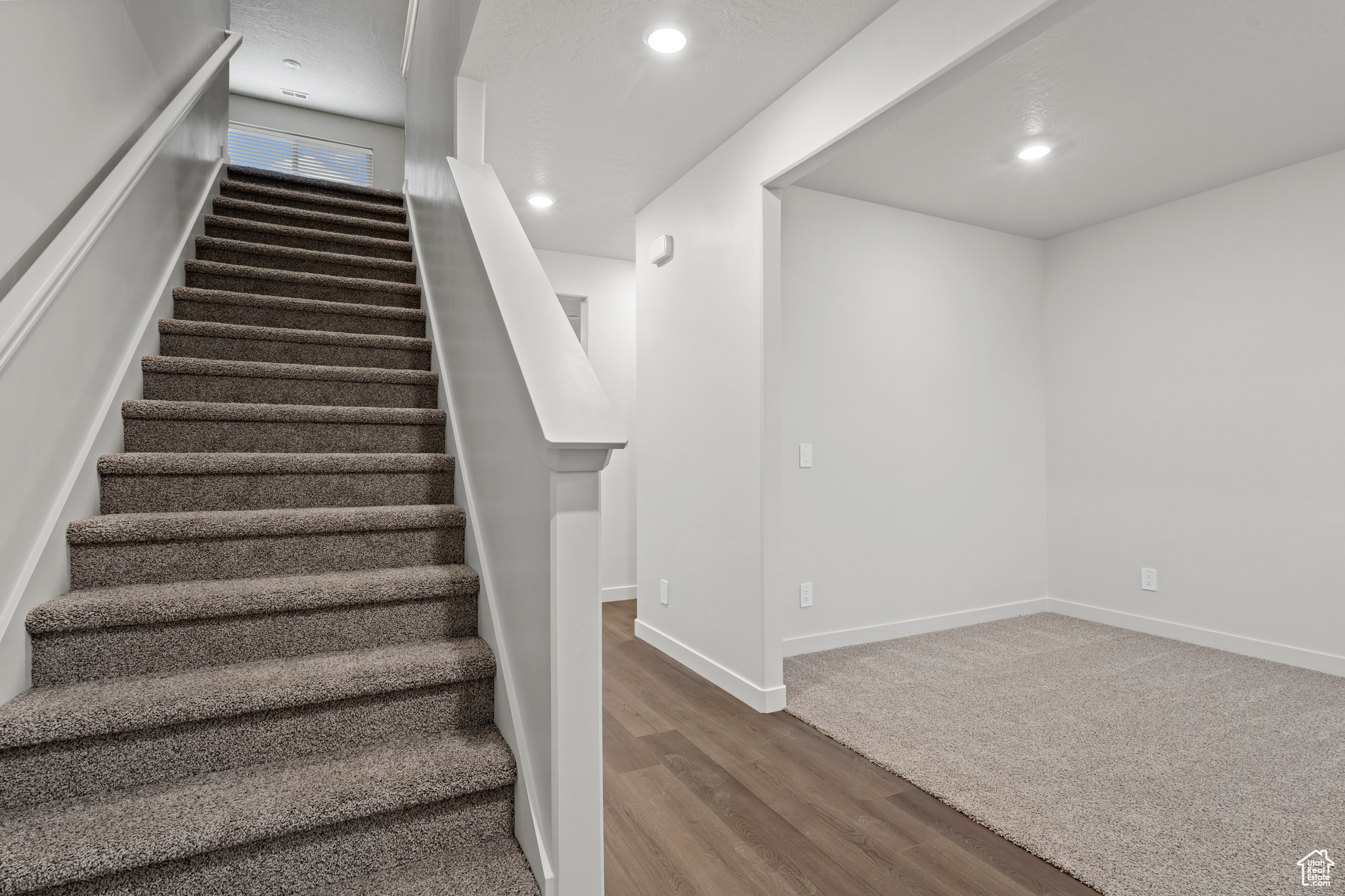 Stairway featuring wood-type flooring