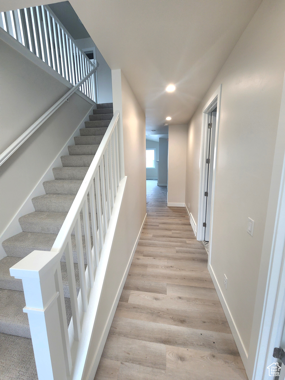 Stairway featuring wood-type flooring