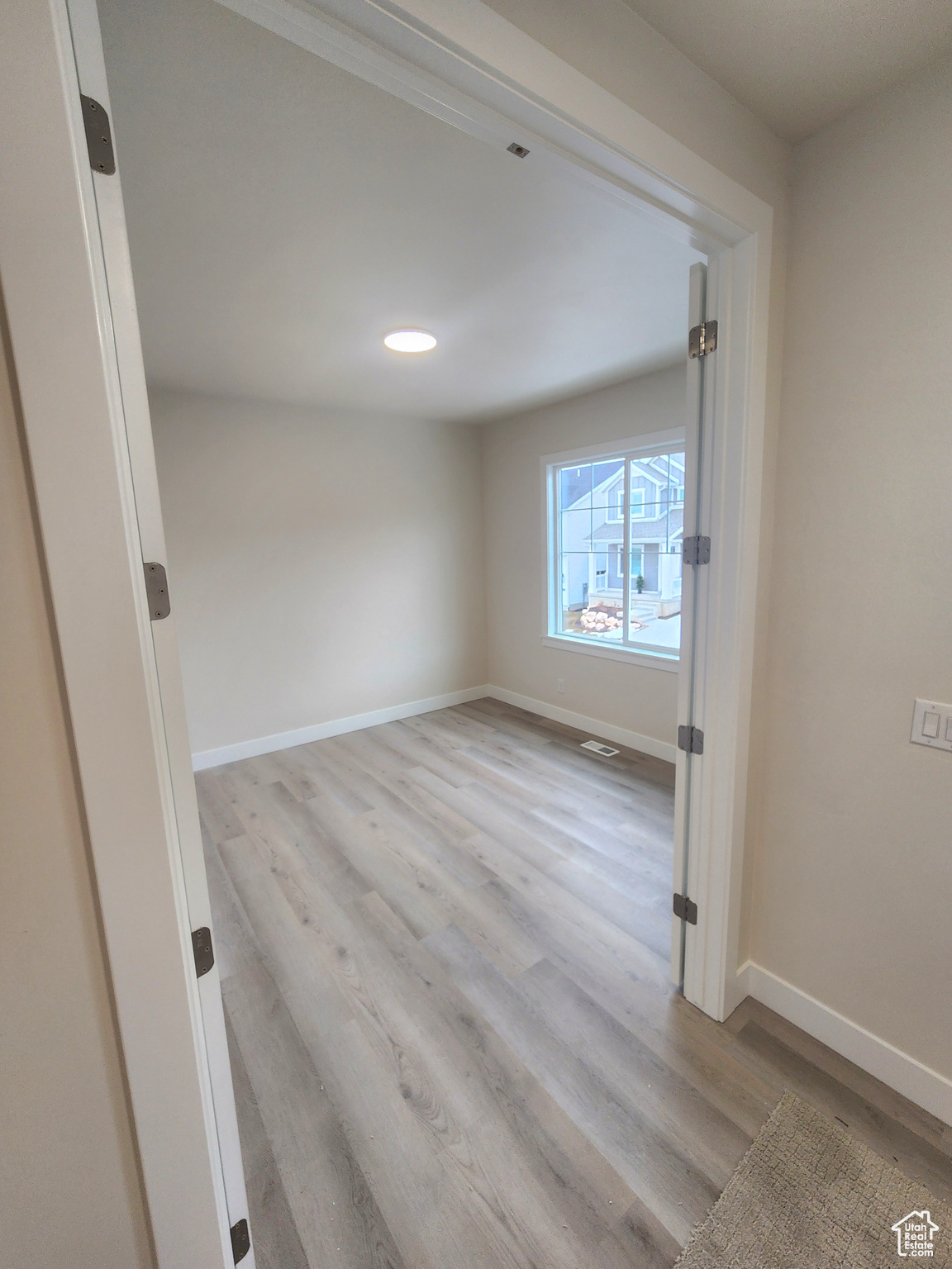 Unfurnished room with light hardwood / wood-style floors