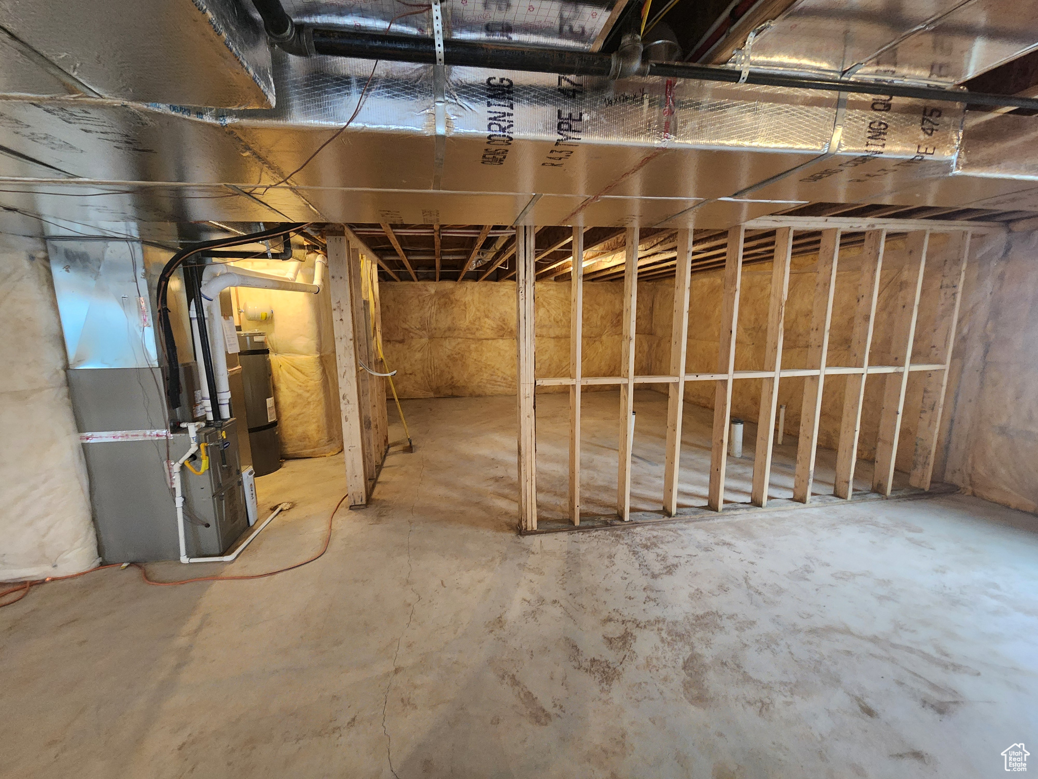 Basement with secured water heater and heating unit