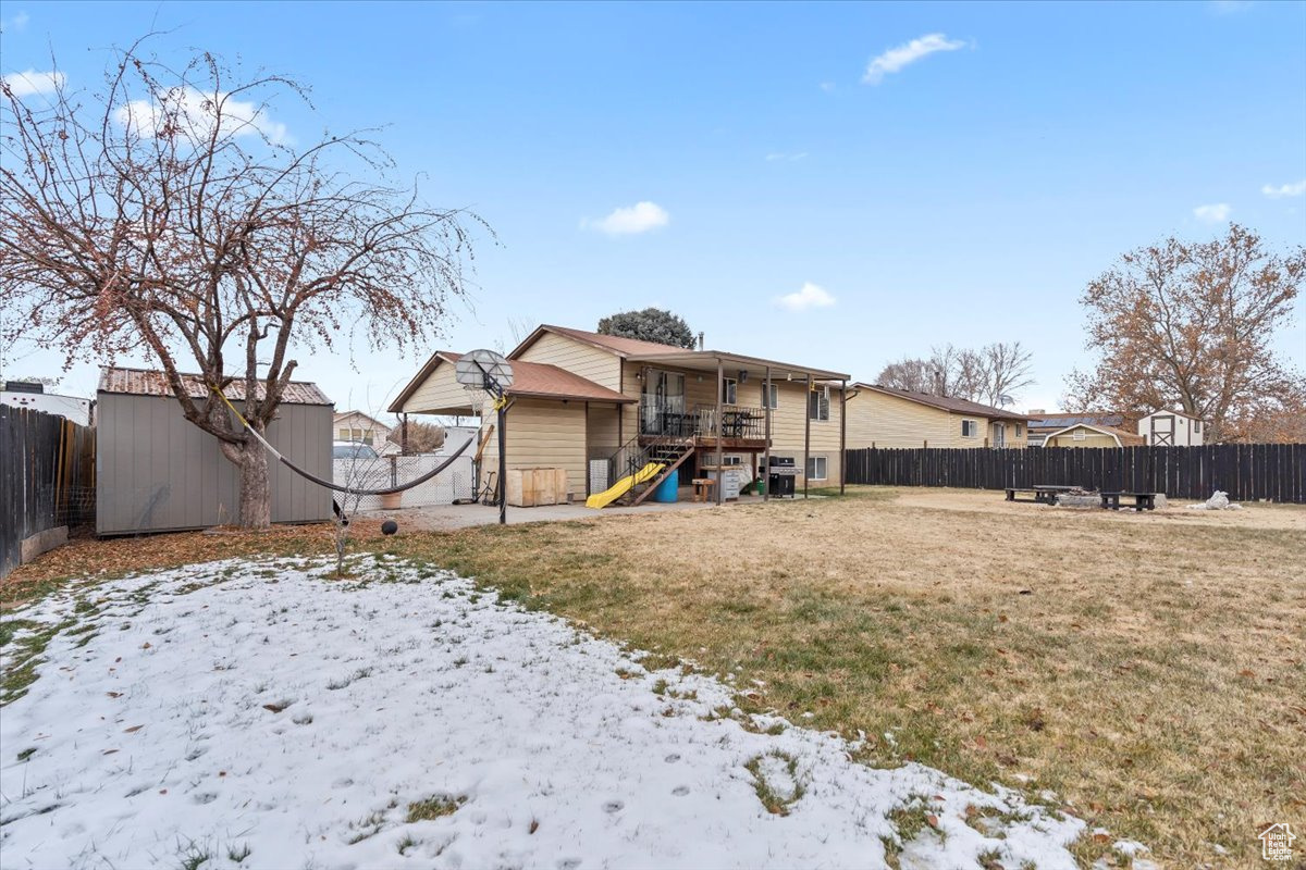 Exterior space with a fire pit, a storage shed, and a yard