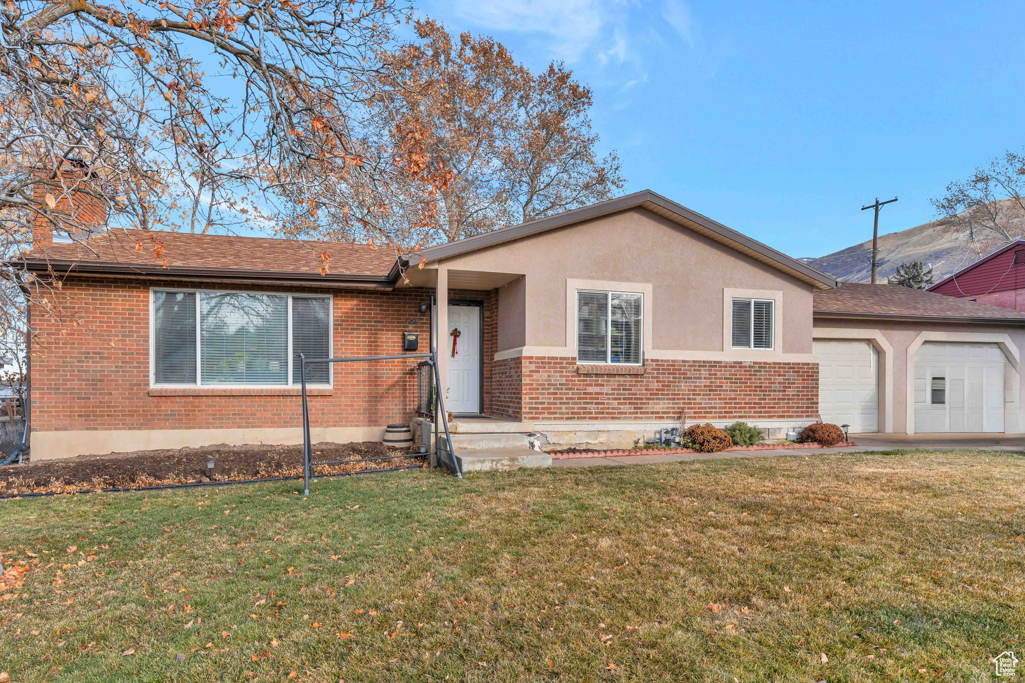 Ranch-style home with a garage and a front yard