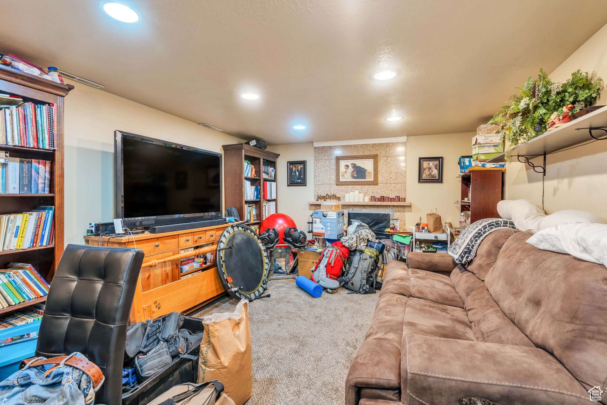 Carpeted living room with a large fireplace