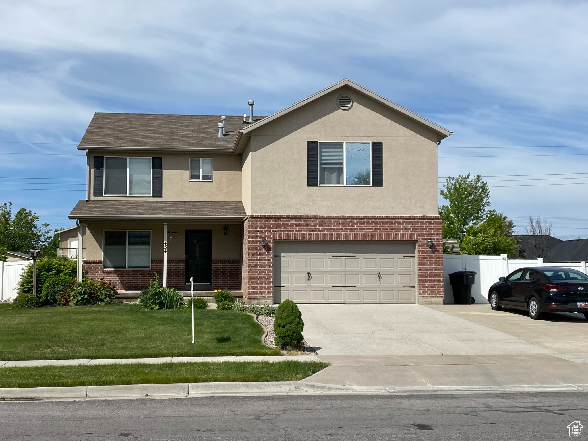 View of front of property featuring a garage and a front yard