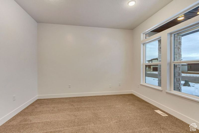 Spare room featuring carpet flooring