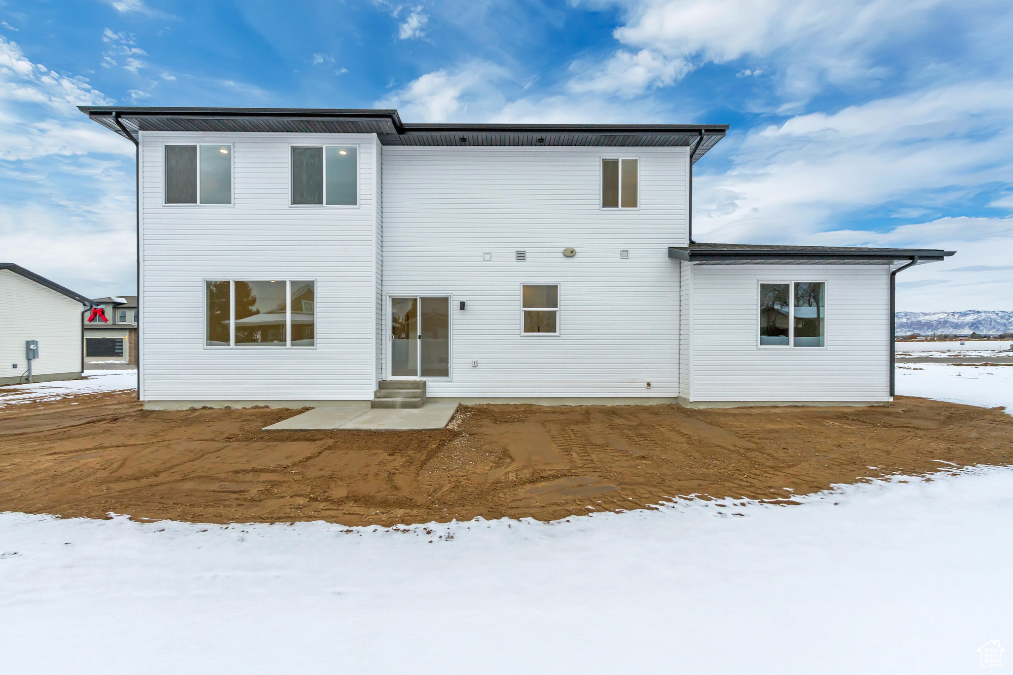 View of snow covered rear of property