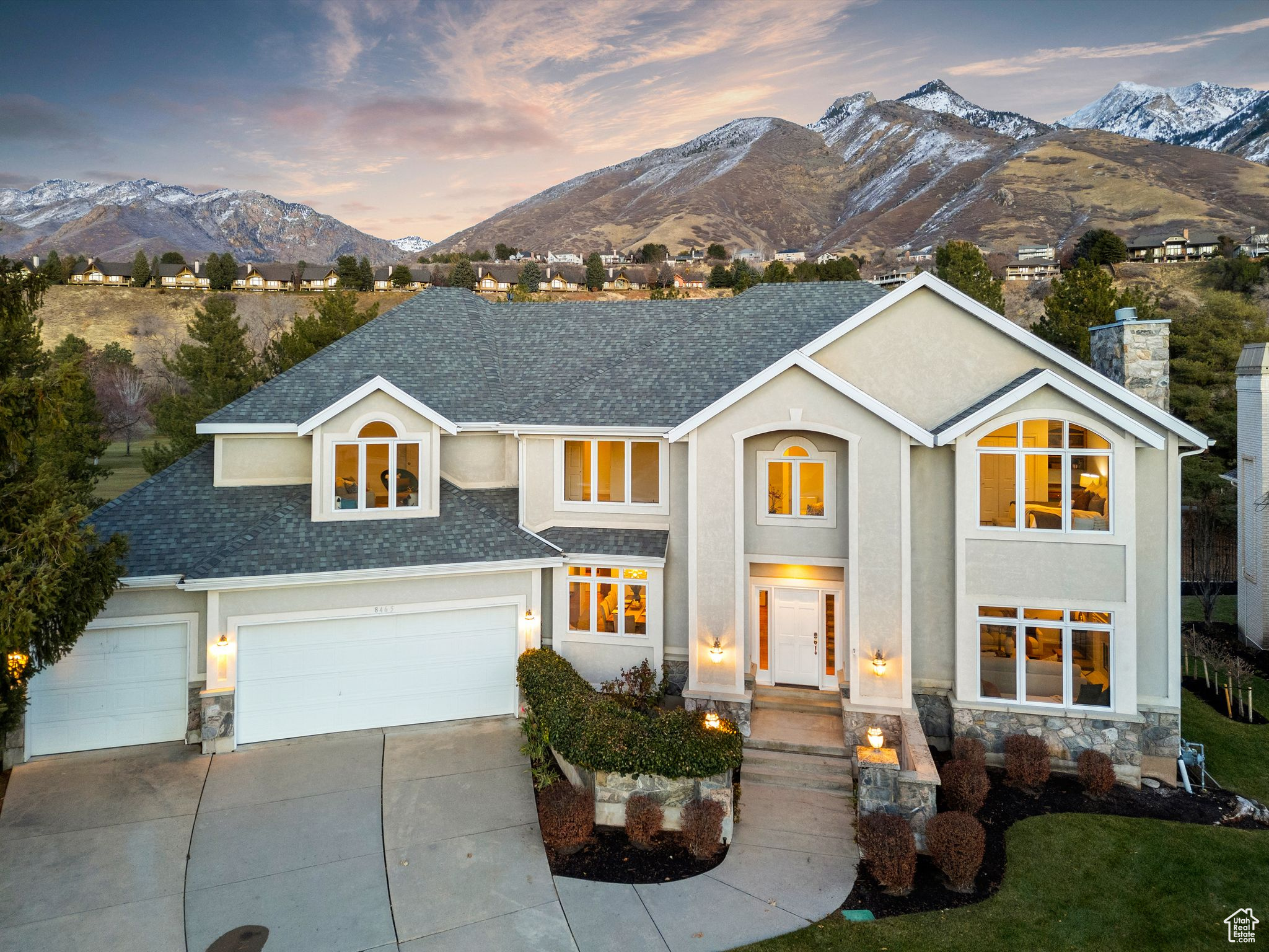 View of front of home with a mountain view and three car garage